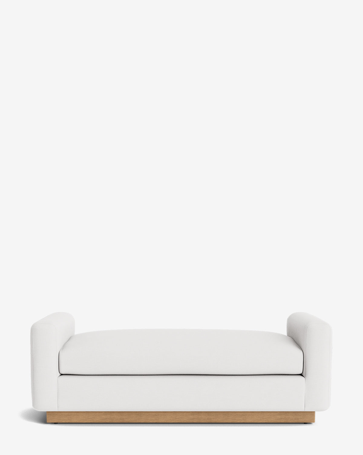 The Mansfield Bench is a modern, handcrafted piece with white upholstery, low rounded armrests, and a wooden base, shown against a plain white background, by Vendixs