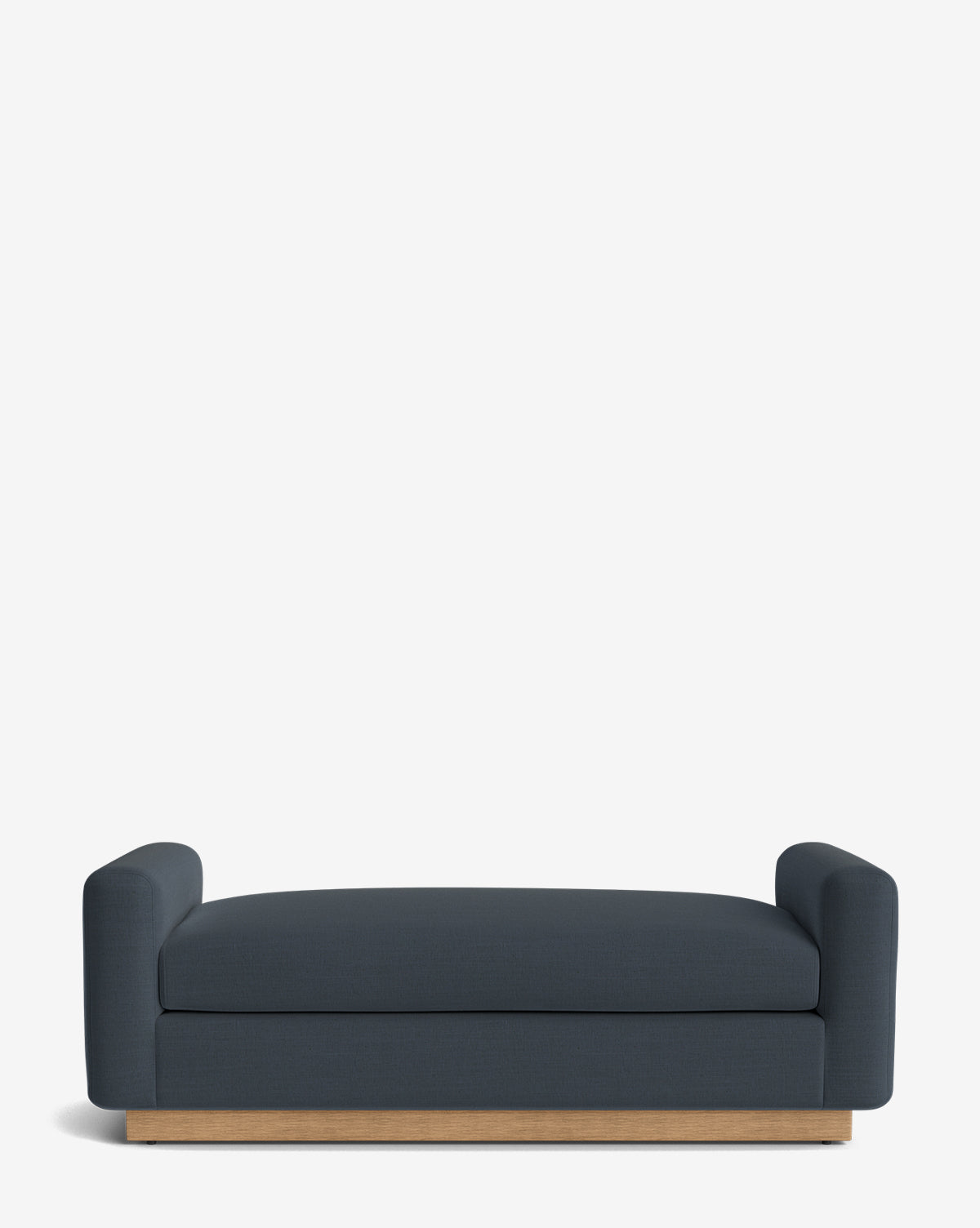 The Mansfield Bench is upholstered in dark blue with rounded arms and a low wooden base, shown against a plain white background, by Vendixs
