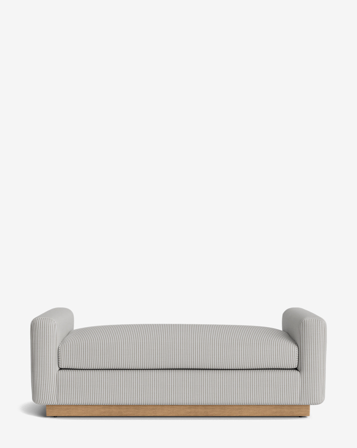 The Mansfield Bench features a modern, low-profile design with light grey upholstery, subtle vertical stripes, short armrests, and a wooden base. Handcrafted and stylish, its shown against a plain white background by McGee & Co.