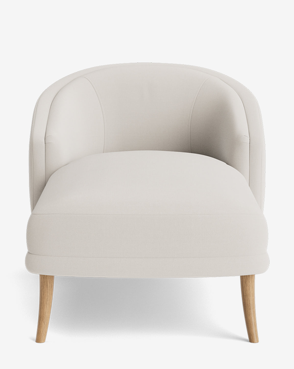 The Marguerite Chaise Lounge is a modern armchair with a curved backrest, upholstered in light beige fabric, and supported by four wooden legs, shown from the front against a white background by McGee & Co.