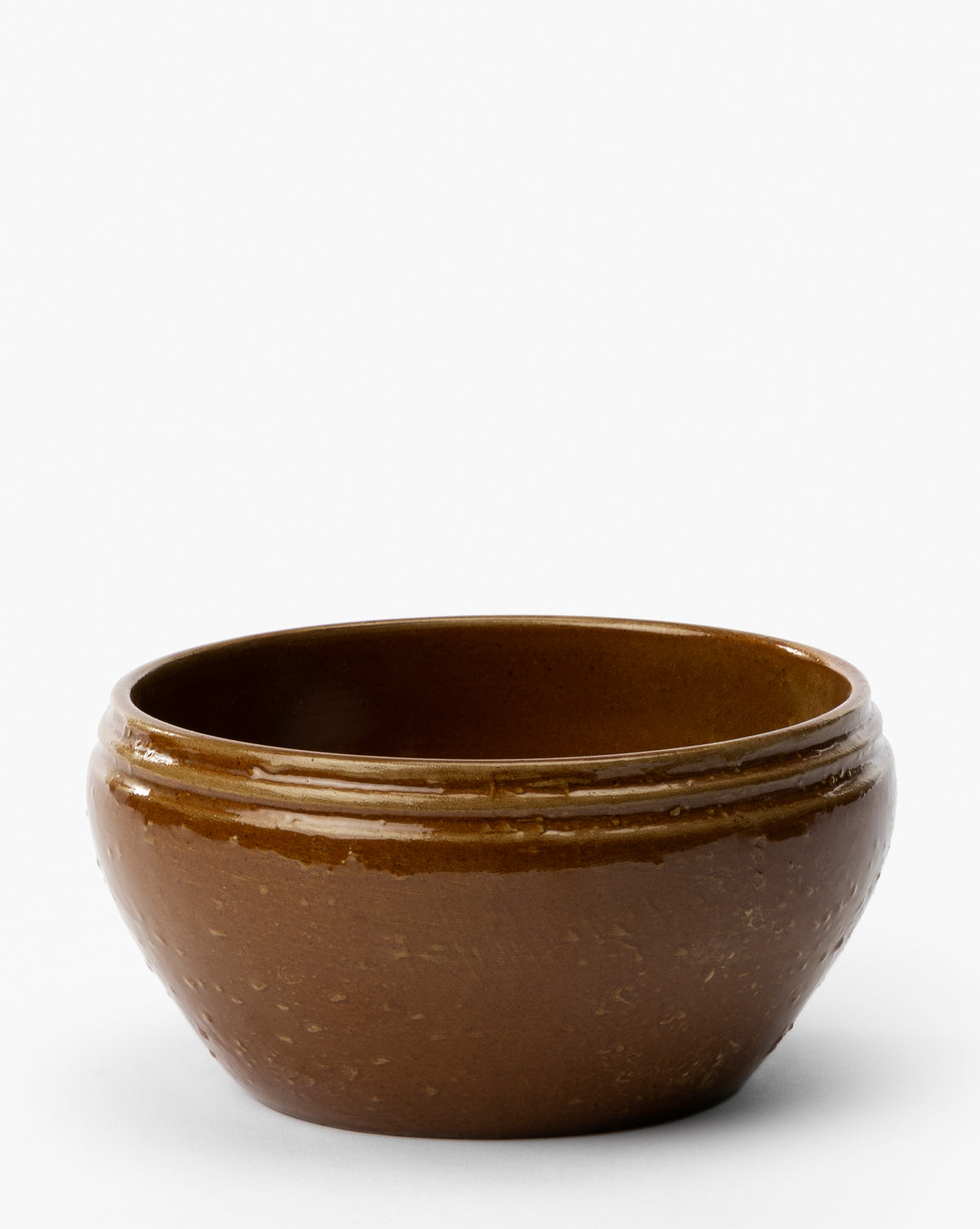 The Mariella Stoneware Bowls (Set of 4) feature a round, brown design with a glossy finish and subtle organic texture, gently curved rims, and a handmade quality—perfect for adding artisanal style to your table, by Vendixs