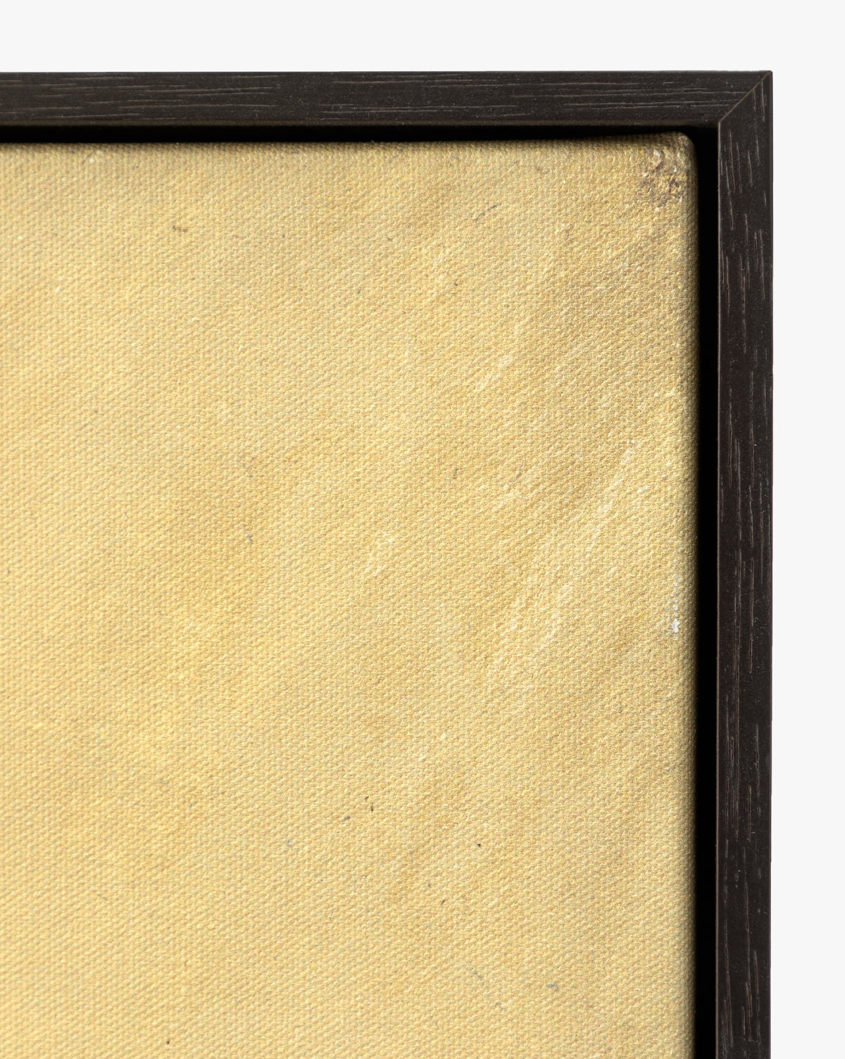 A close-up of the top right corner of Mark Making, a textured, beige gallery-wrapped canvas in a slim, dark wooden frame, shown against a white background, by Vendixs