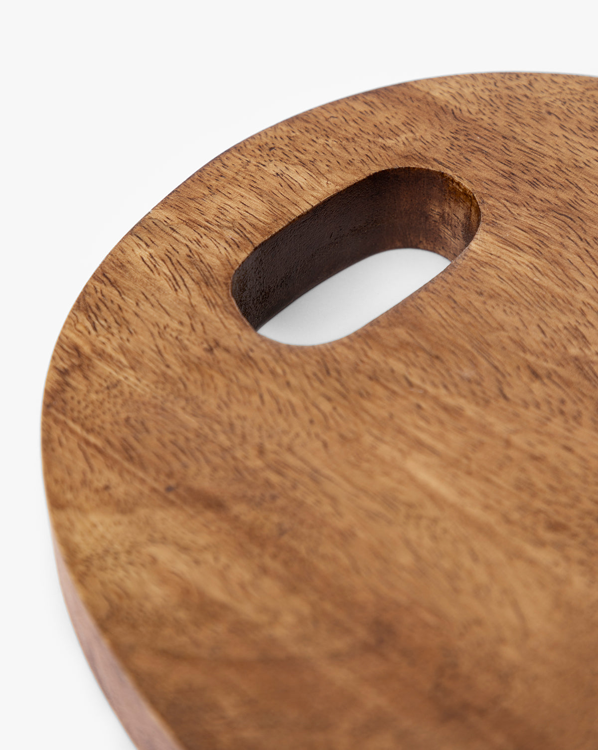 Close-up of the Marlton Breadboard, a round wooden serving board with a smooth surface and an oval cut-out handle, ideal for artisanal kitchen decor, shown against a white background by Vendixs