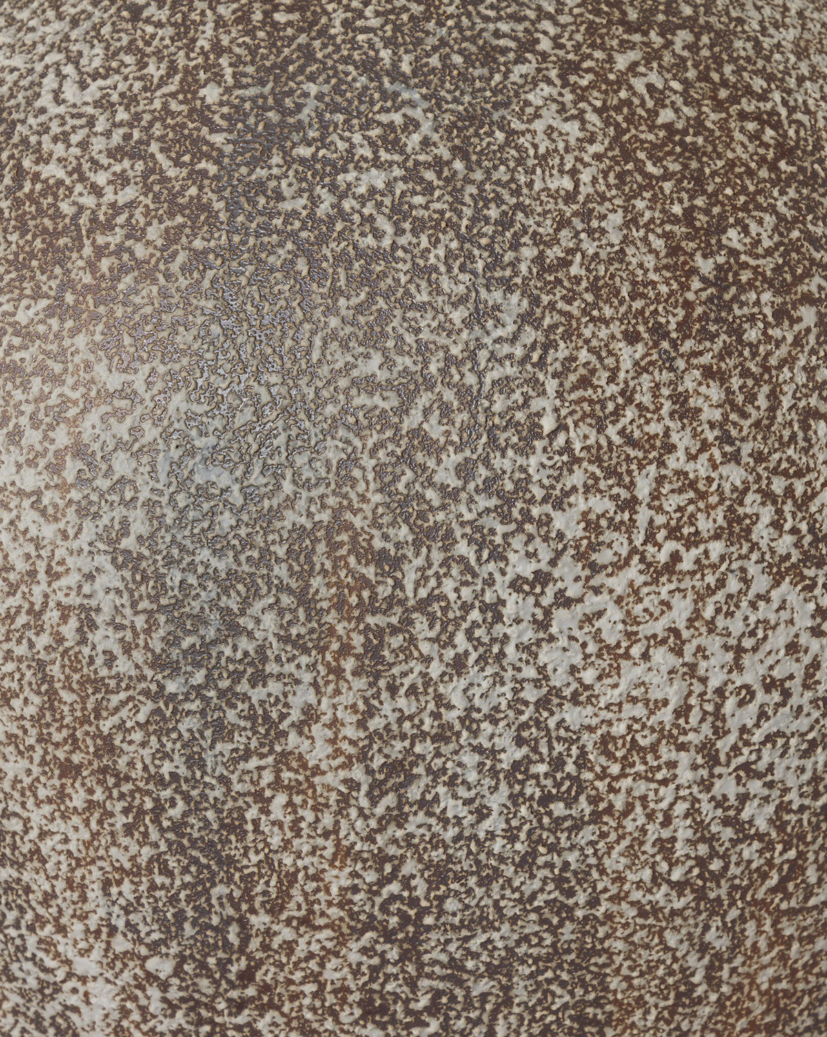 Close-up of the speckled brown and white textured surface of the Mays Table Lamp, reminiscent of a vintage clay jar or weathered sand-colored talavera glaze, by Vendixs