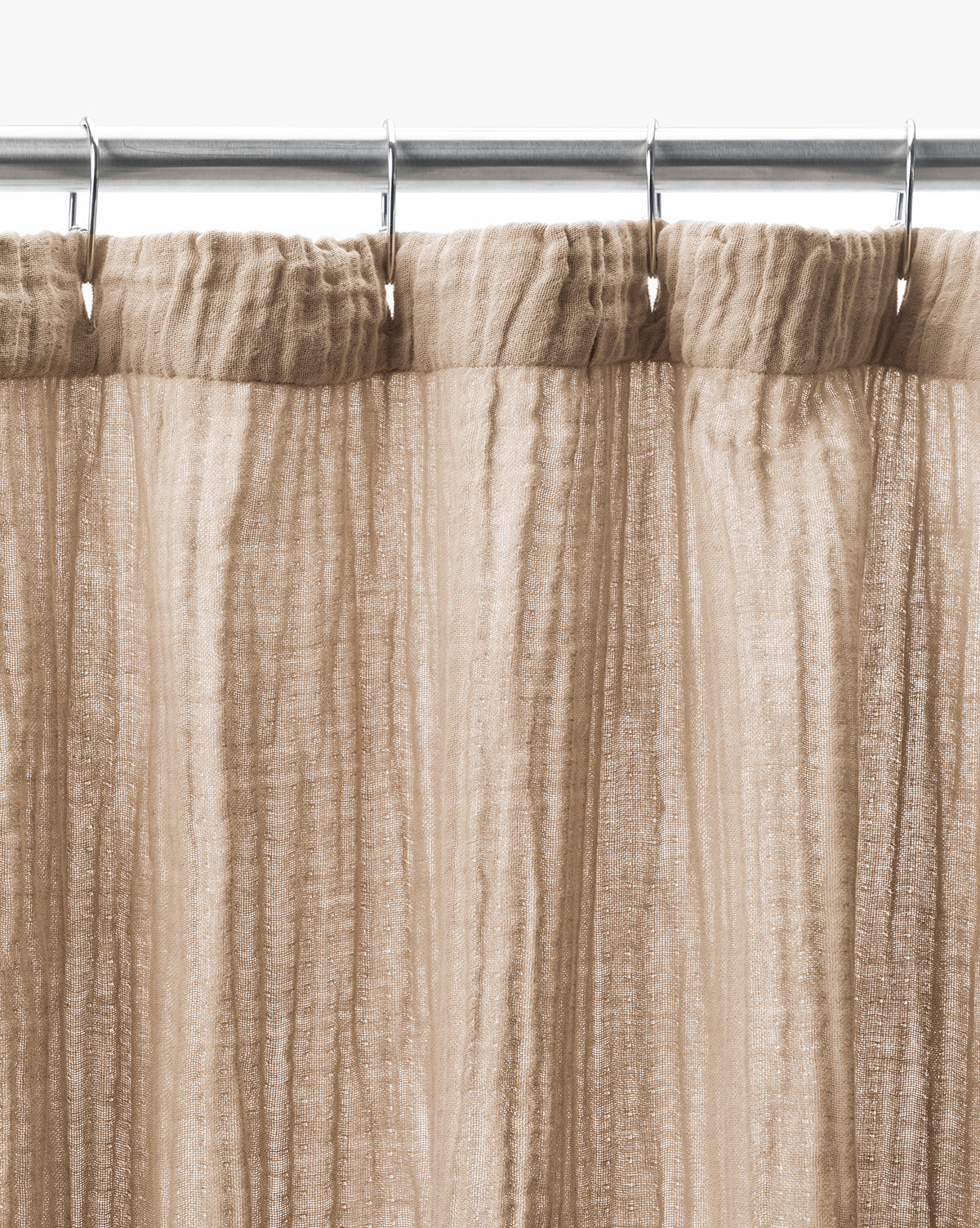The Mirella Shower Curtain, in light brown double-layer sheer fabric with vertical textured lines, hangs from a silver rod with hooks. Shown close-up against a white background, its semi-transparent design adds an elegant touch.