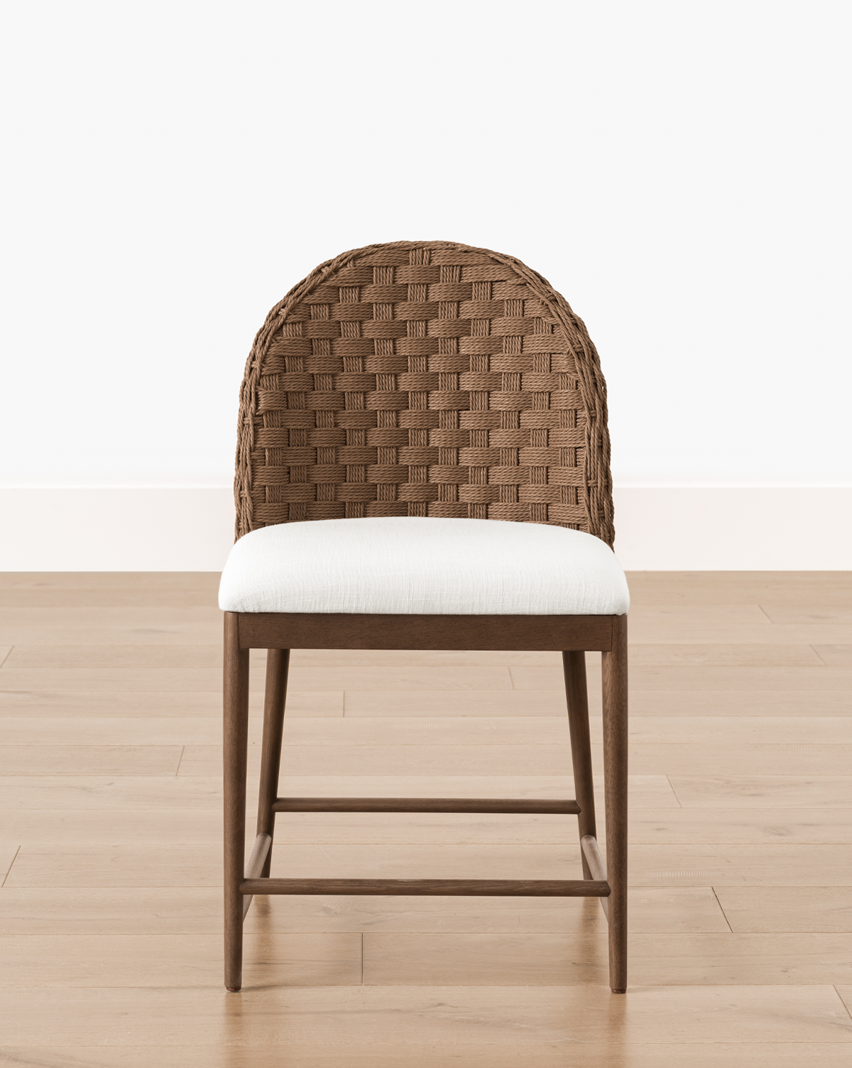 The Molly Dining Chair boasts a woven, rounded backrest and white cushioned seat, making it an ideal modern piece for contemporary dining spaces, by Vendixs