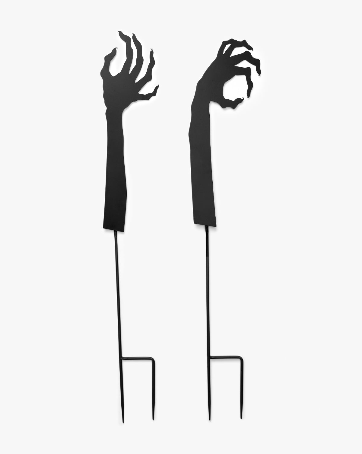 Creative Co-op’s Monster Hands Yard Stakes (Set of 2) feature black, clawed zombie arms for spooky Halloween yard décor that will frighten and delight your guests—now with a touch of style inspired by Vendixs