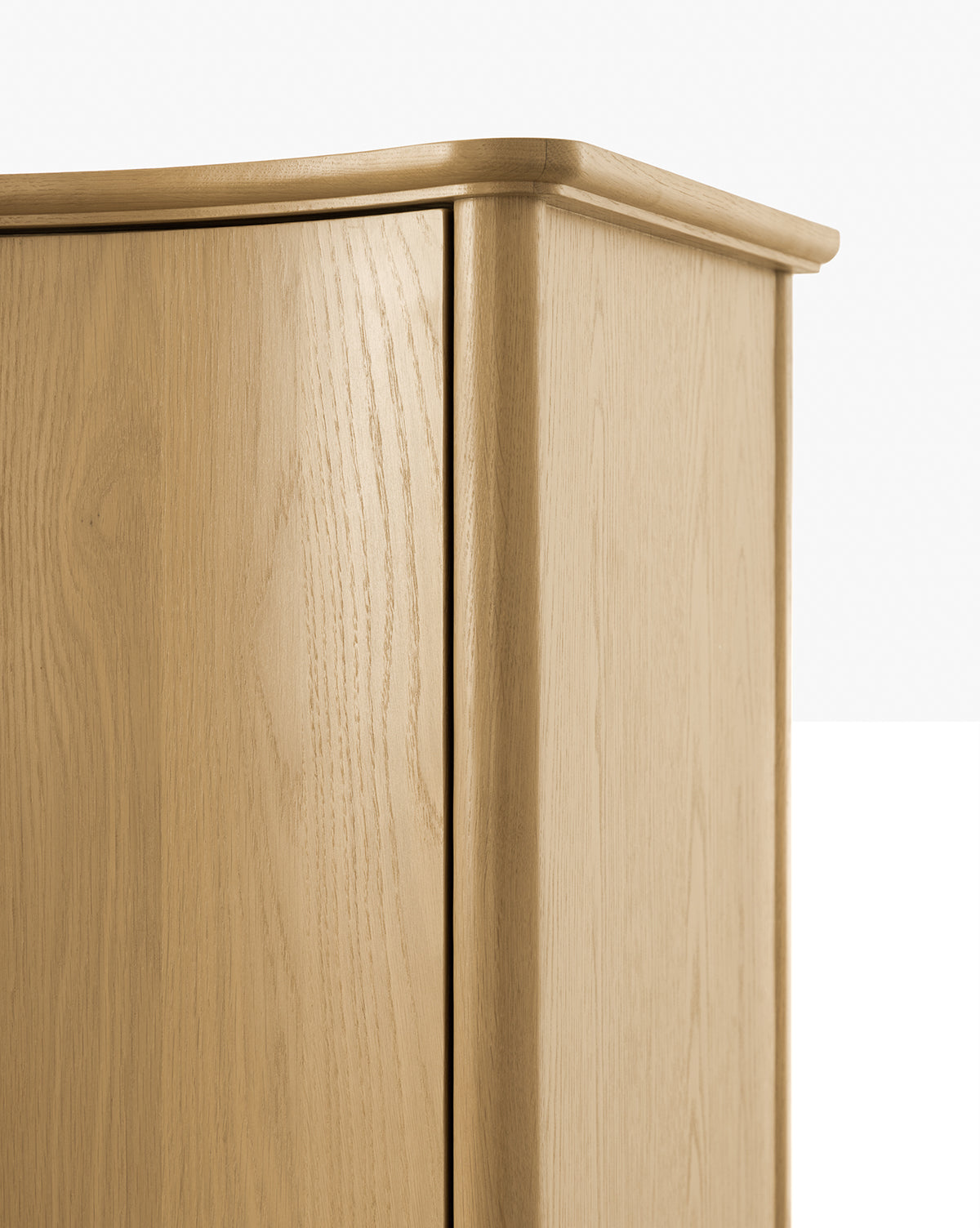 Close-up of the top corner of a Moorland Cabinet, featuring smooth edges, subtle wood grain texture, and a clean, minimalist design—perfect for modern living room storage against a plain background by Vendixs