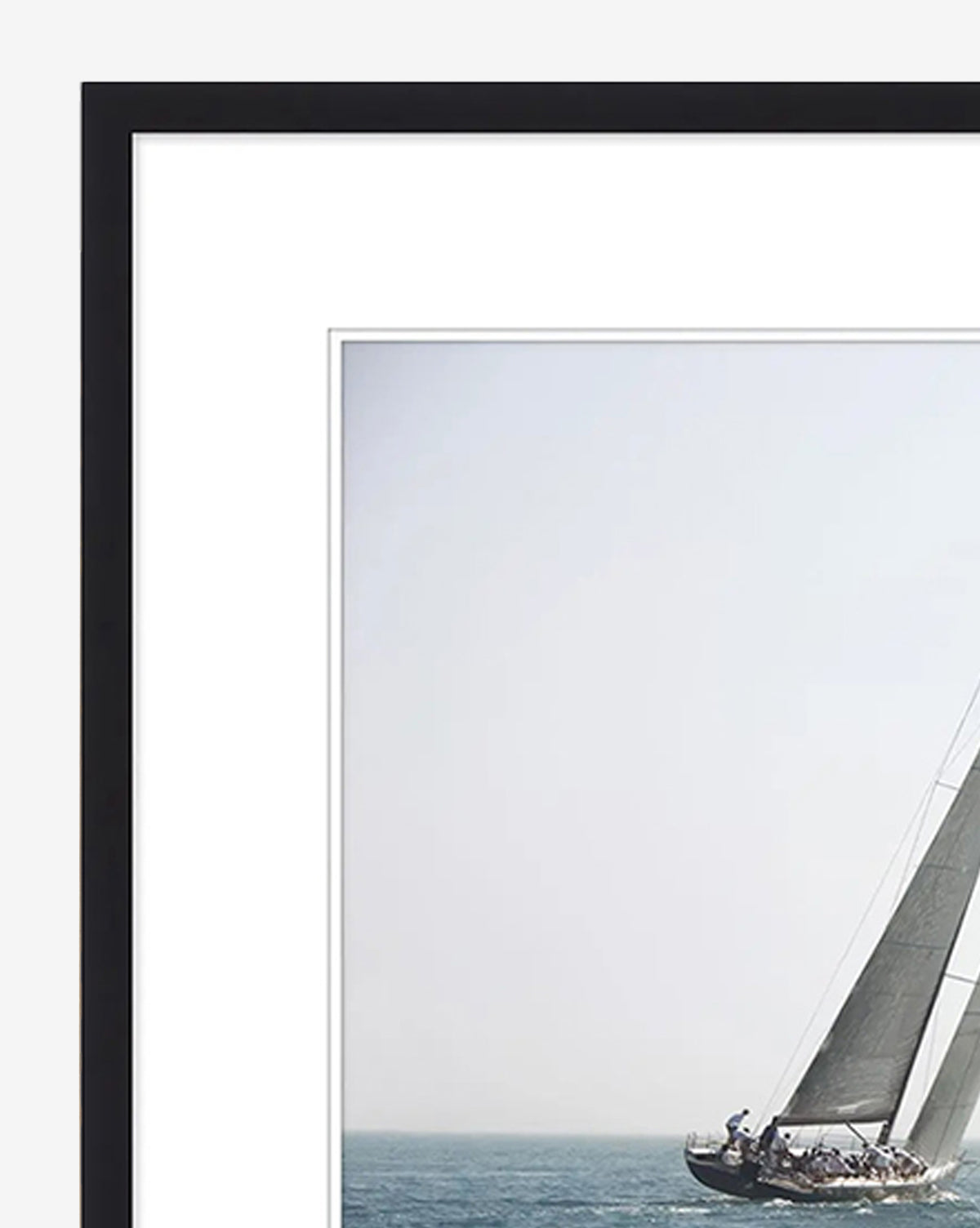 Motion is a framed giclee print featuring a sailboat heeling under full sail with crew aboard, set against a calm ocean and pale sky—ideal wall art to bring tranquil coastal vibes to your home, by McGee & Co.