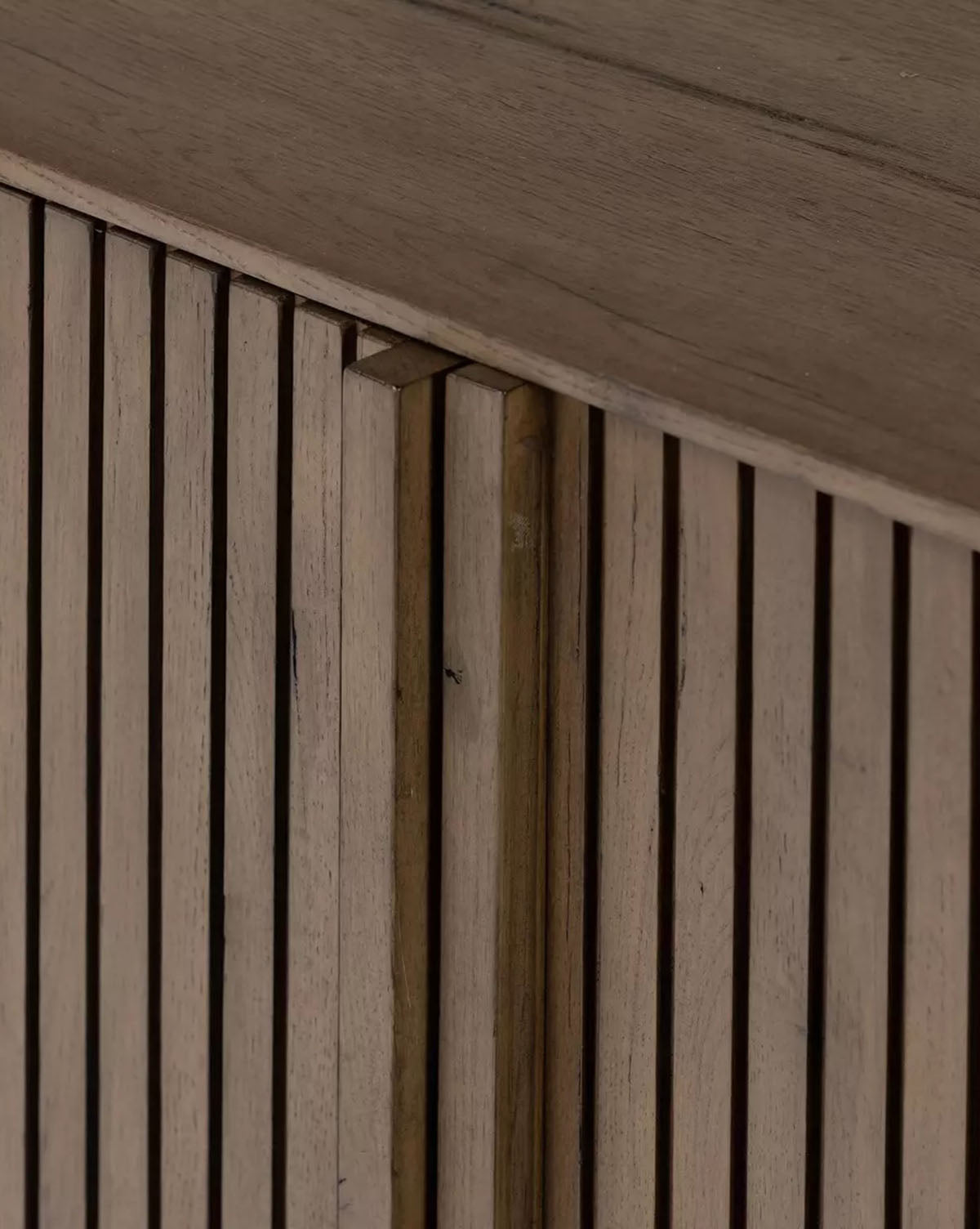 Close-up of the Murron Sideboard’s wooden construction and vertical slats. Fluted door fronts showcase the natural grain, creating modern geometric patterns with light and shadow—ideal for stylish entryway storage by McGee & Co.