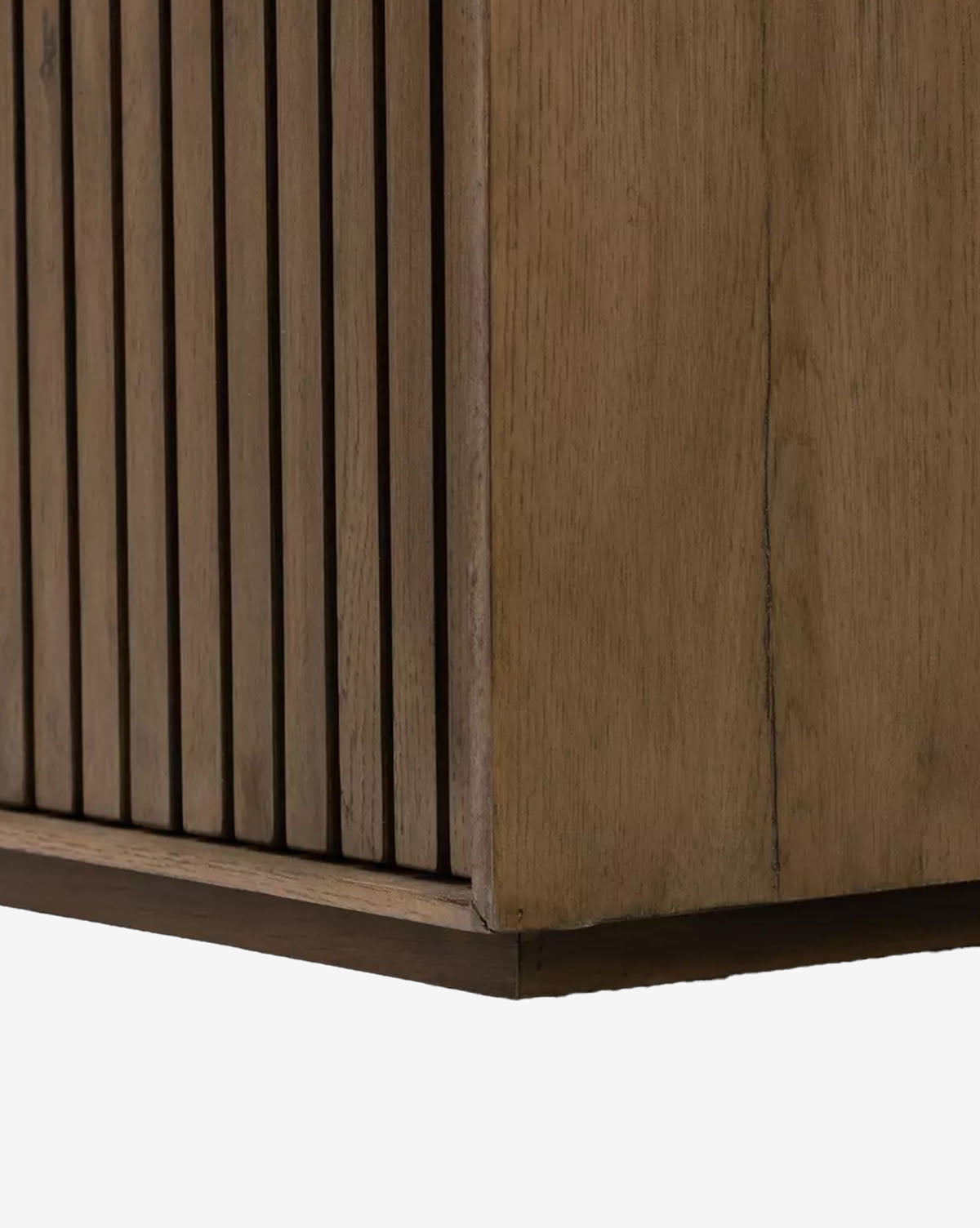 Close-up of the Murron Sideboards corner, showcasing vertical slats reminiscent of fluted doors on one side and a smooth wood panel on the other, highlighting its natural wood grain and texture, by Vendixs