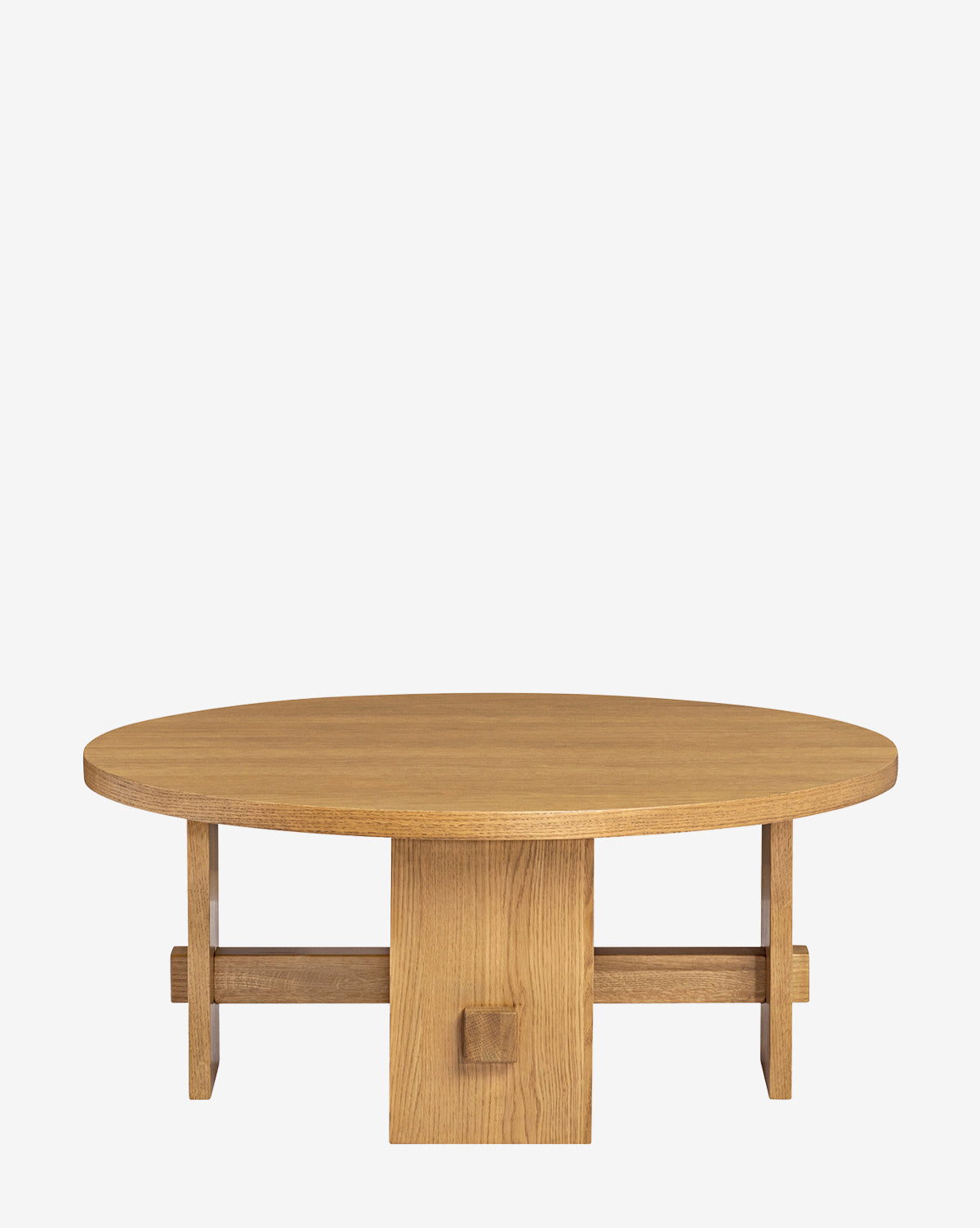 The Newbold Coffee Table is a round oak table with a smooth top and sturdy geometric base made of intersecting planks, finished in warm honey, shown on a plain white background, by Vendixs