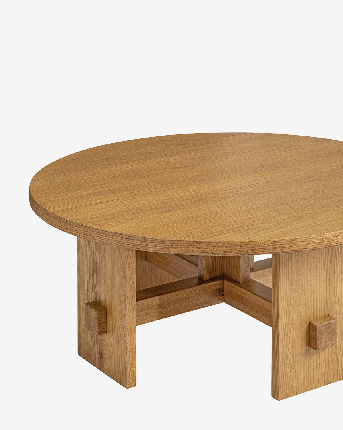 The Newbold Coffee Table showcases a round oak top in a honey finish with sturdy block legs, displayed on a plain white background, by Vendixs