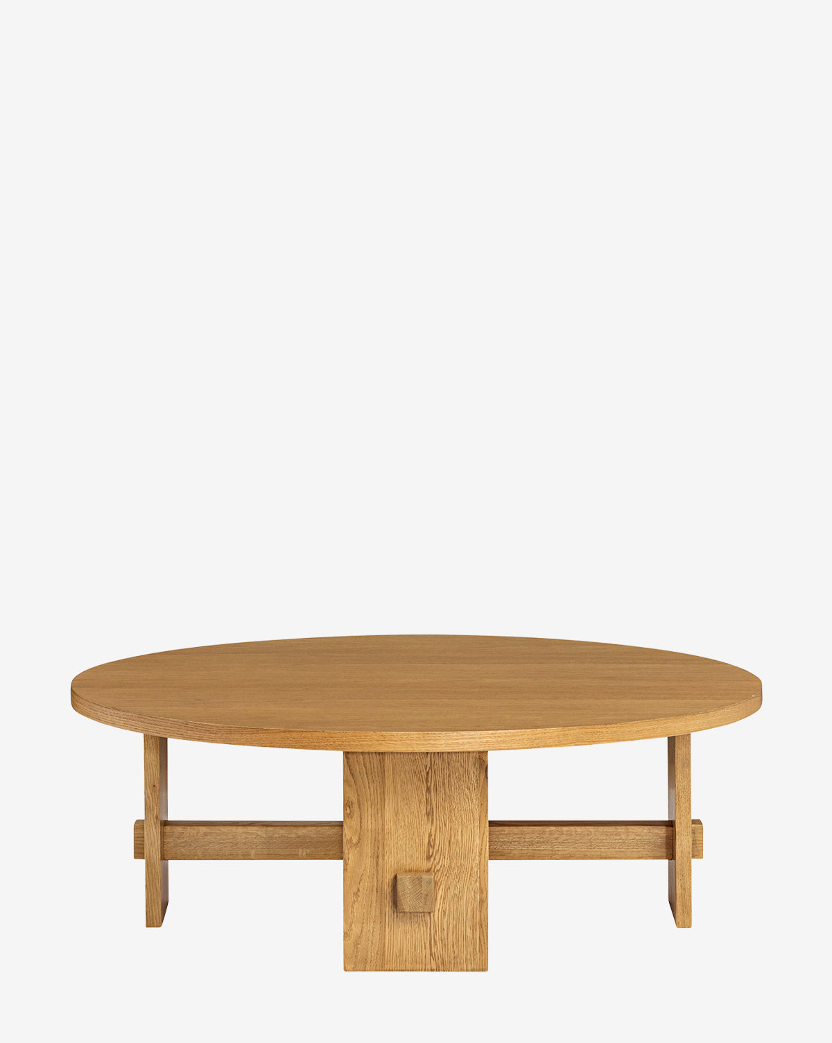 The Newbold Coffee Table is a round oak table with a honey finish, featuring a thick top and a unique geometric base of intersecting beams, shown against a plain white background, by McGee & Co.