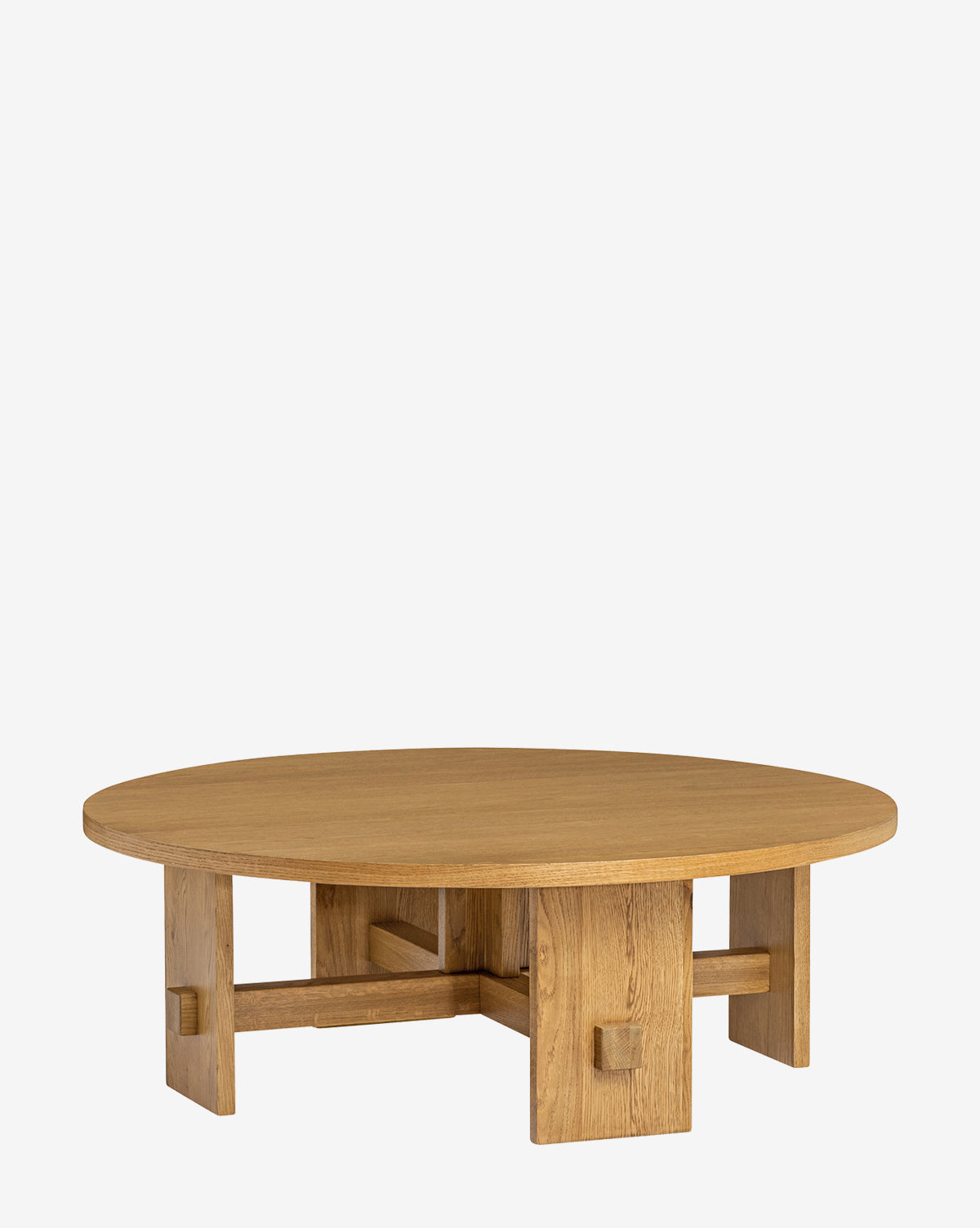 The Newbold Coffee Table is a round oak table with a natural finish, thick tabletop, and sturdy geometric base featuring intersecting rectangular legs, by Vendixs