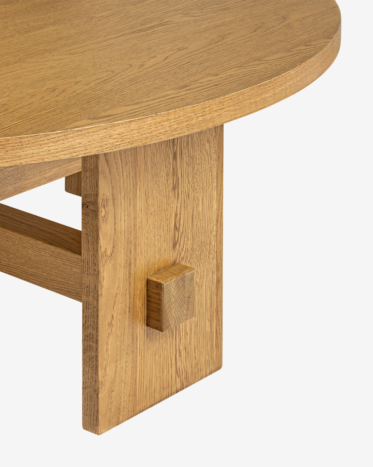 Close-up of the Newbold Coffee Table, highlighting its round top, sturdy block leg, natural oak wood grain, and honey finish set against a simple white background, by Vendixs
