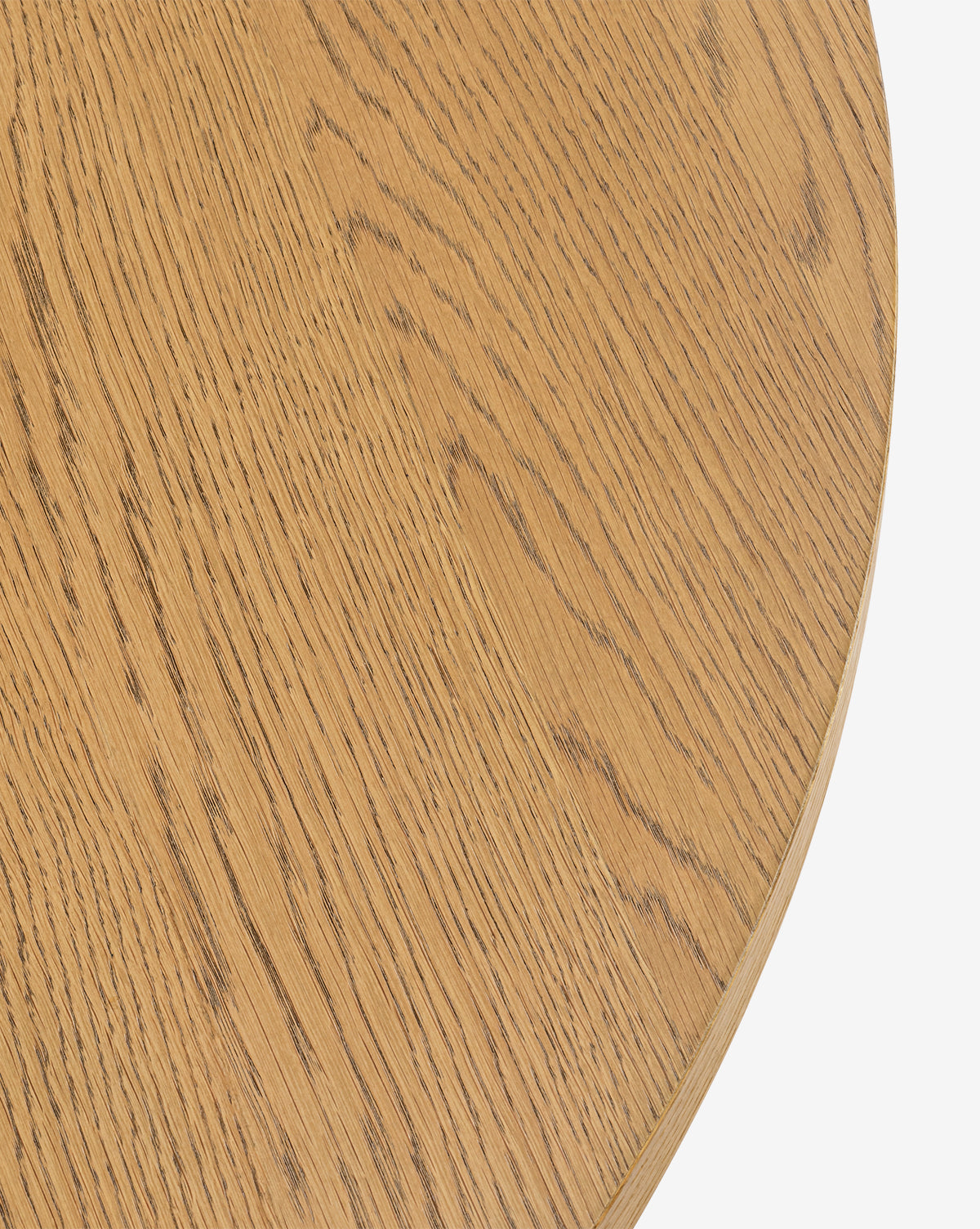 Close-up of the Newbold Coffee Table, a round oak piece in light brown with a honey finish, highlighting its natural wood grain against a plain white background, by Vendixs