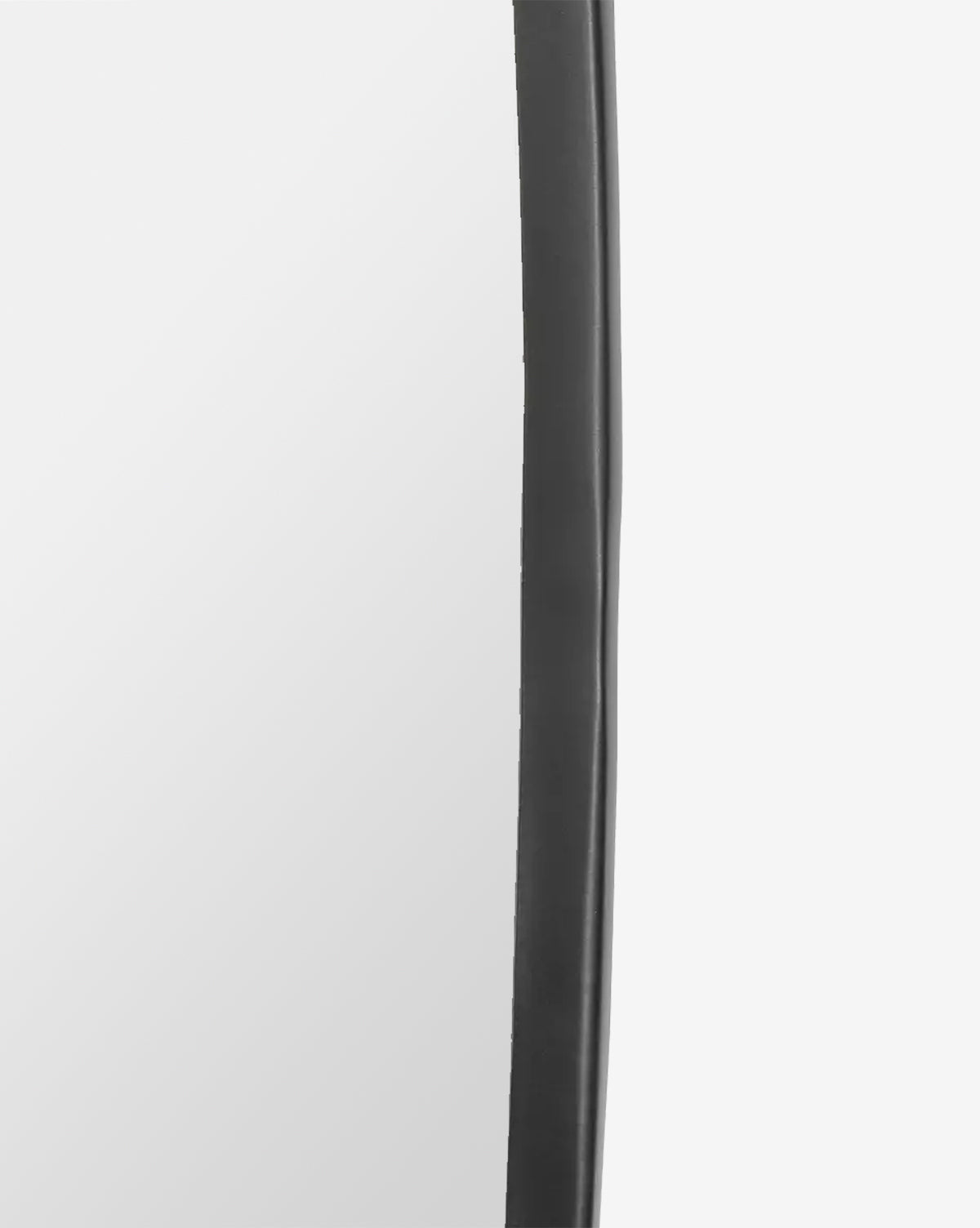 Close-up of the Nolie Wall Mirrors edge, showing its matte black, slightly wavy iron frame against a light gray background, by Vendixs