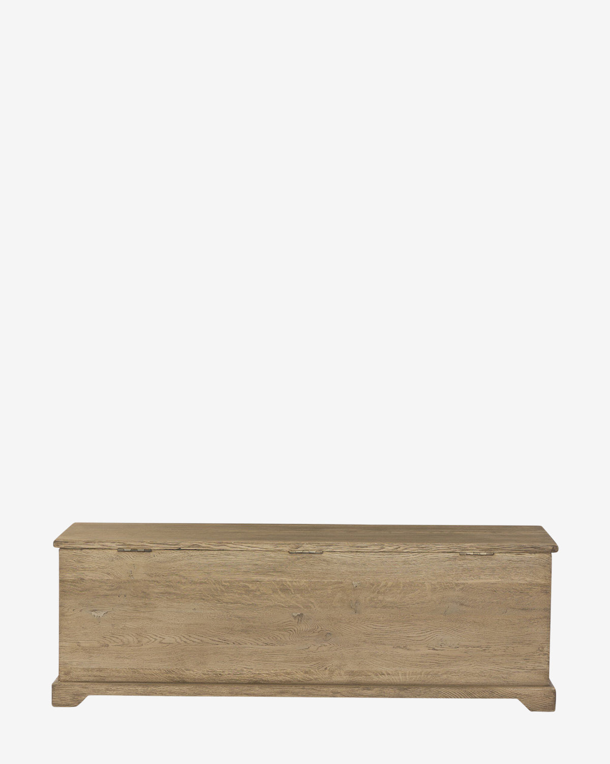 The Norman Bench by Four Hands is a rectangular built-in storage bench with a hinged lid, made from light brown solid oak, functioning as both an entryway bench and storage chest, shown against a plain white background. Vendixs