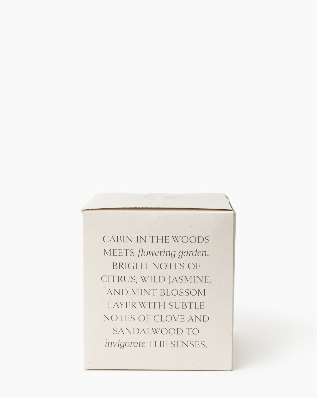 A cream box displays the Oak & Orange Blossom Candle: “Cabin in the woods meets garden—bright citrus, wild jasmine, and mint blossom blend with hints of clove and sandalwood for an invigorating scent,” by Vendixs