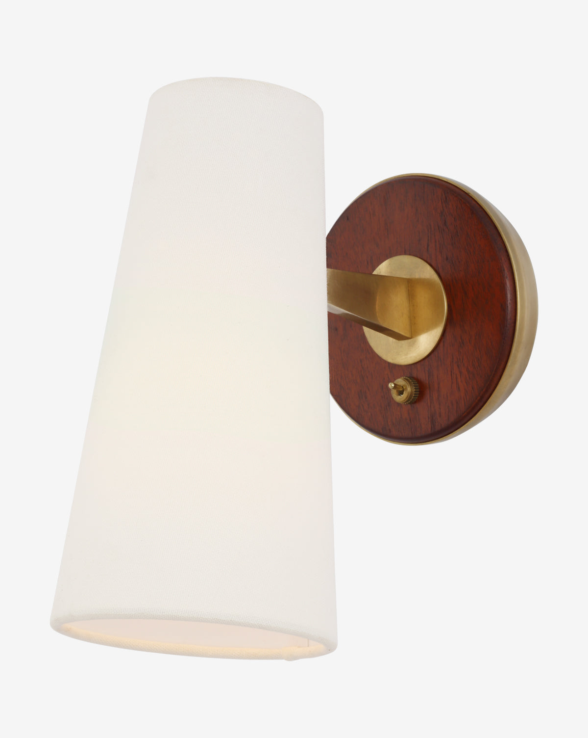 The Olina Sconce by Visual Comfort & Co. Signature is a wall-mounted fixture with a conical white linen shade, brass arm, circular base, dark wood backplate accents, and a small brass switch. Vendixs