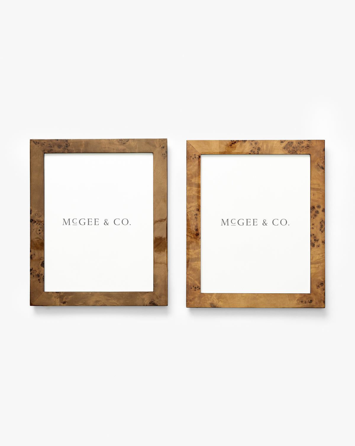 The Oliver Burl 8x10 Frames (Set of 2) feature wooden frames in different brown finishes, each showcasing a white Vendixs paper and displayed side by side on a plain white background by Vendixs
