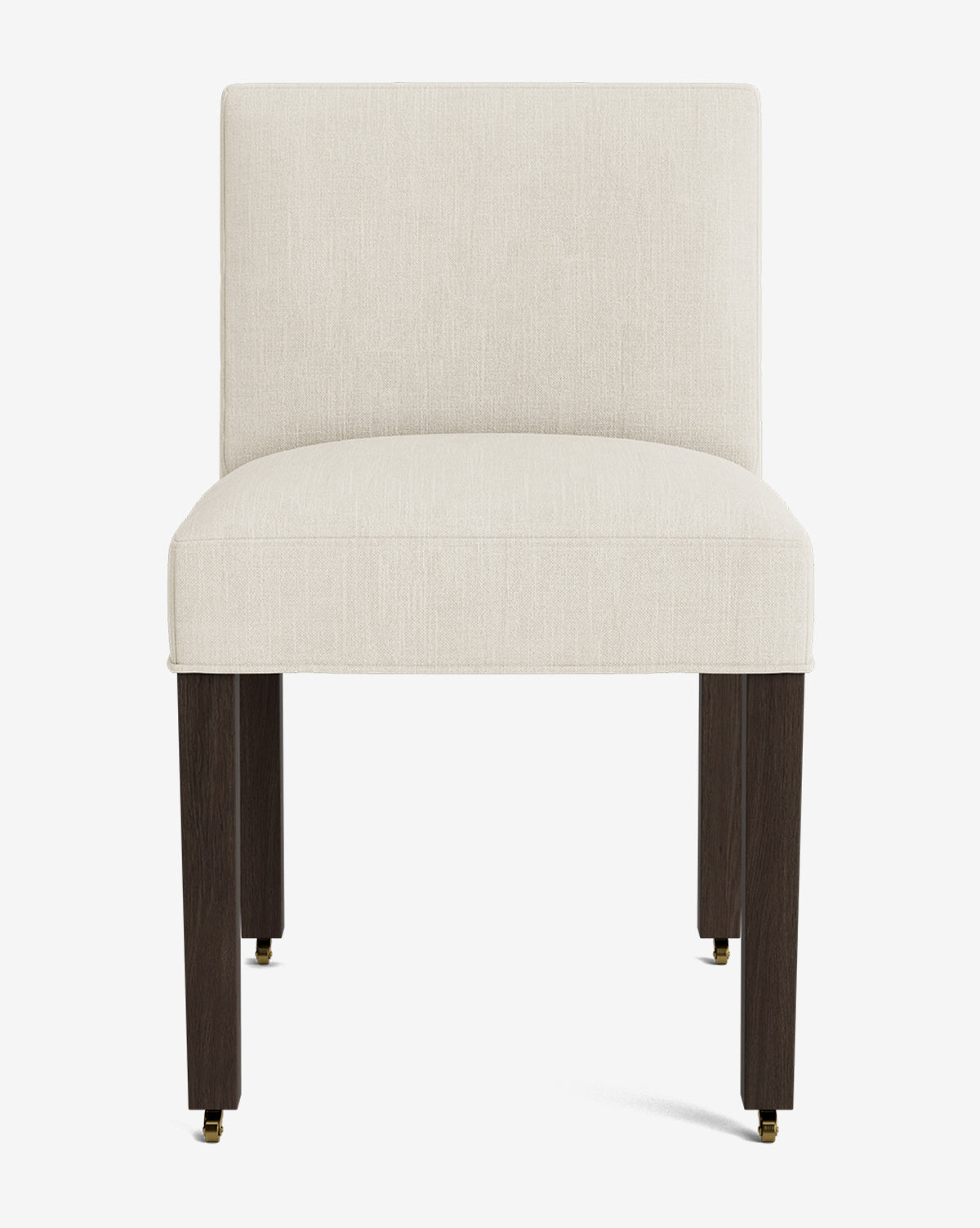The Olivier Upholstered Dining Chair features a modern armless design with a cream fabric seat and backrest, supported by four dark wooden legs and small brass casters on the front legs, by Vendixs