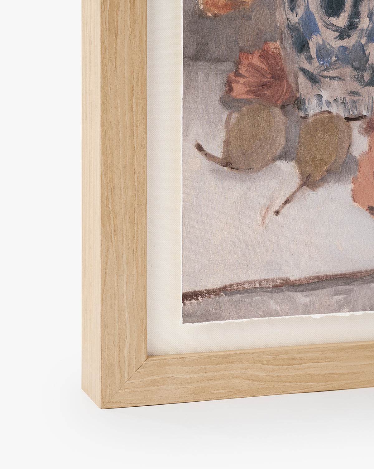 A close-up of a light wooden picture frame displays Orange Florals Still Life watercolor wall art—autumn leaves, two pears, and a blue-patterned vase on a light background, by Vendixs