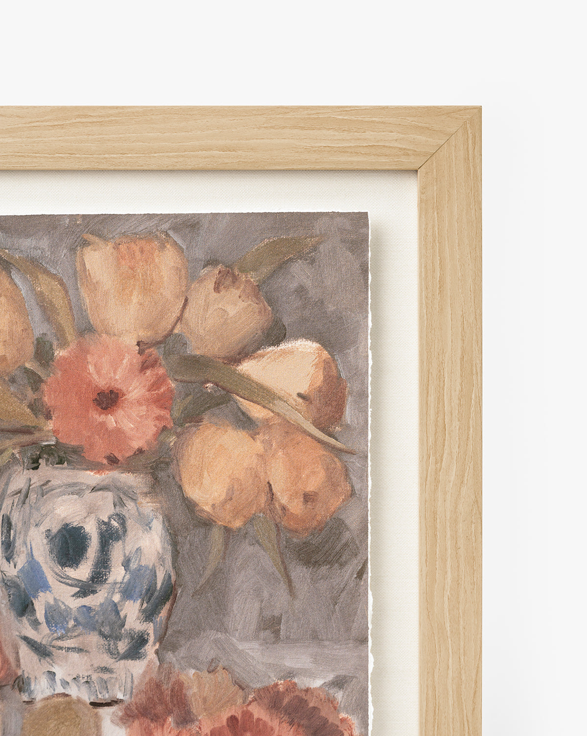 A close-up of Orange Florals Still Life, a framed watercolor with peach-toned flowers in a blue and white vase. Set in a light wood frame with a gray background, this elegant art suits any space by Vendixs