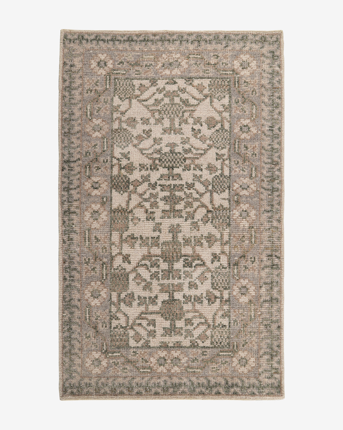 The Orsino Hand-Knotted Rug is a rectangular, antique-style piece featuring a muted, vintage-inspired pattern with geometric and floral motifs in beige, gray, and green tones. A decorative border frames its intricate central design by Vendixs
