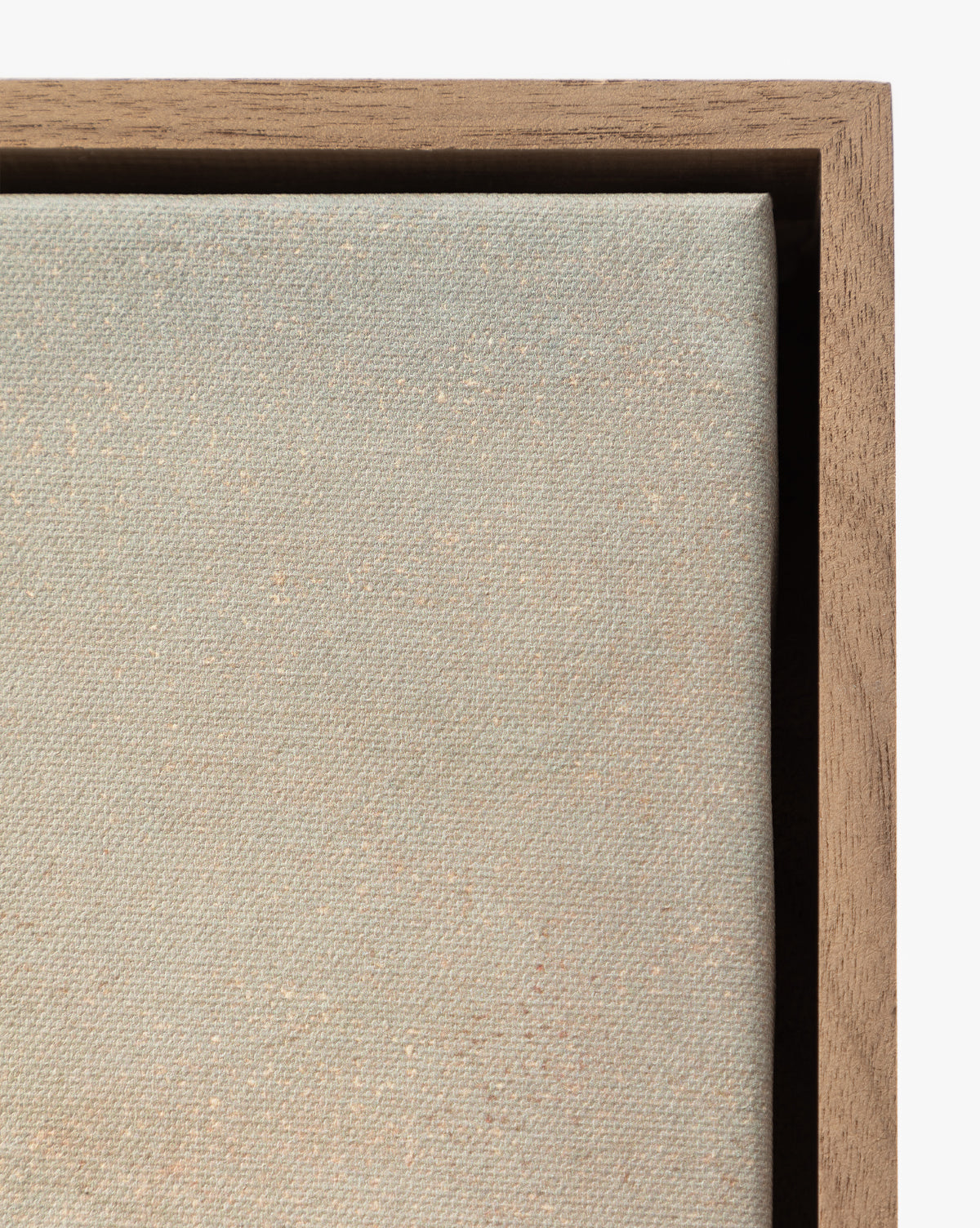 Close-up of the beige textured fabric of Overlook stretched on canvas, partially framed with wood and corner visible in the upper right—a striking detail in this museum-quality wall art, by Vendixs