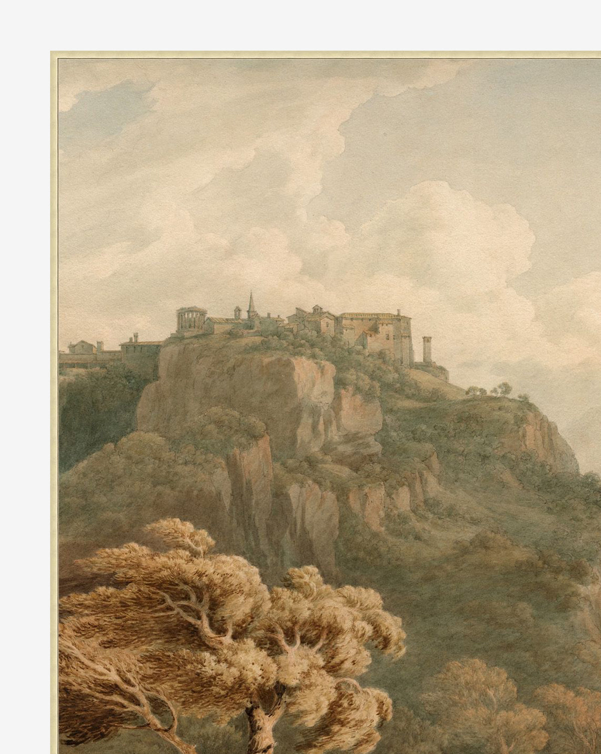 Overlooking Tivoli is a scenic painting depicting a hilltop village with stone buildings and church atop cliffs, detailed brushwork, foreground trees, and a cloudy sky. Presented in a silver finished wood frame, by McGee & Co.