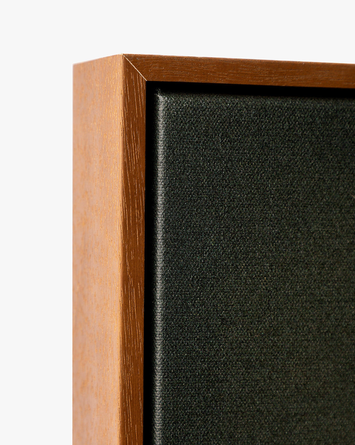 Close-up of the corner of a Painters Depths wooden-framed black fabric speaker against a white background, highlighting the wood and fabric texture, reminiscent of gallery-wrapped abstract wall art, by Vendixs
