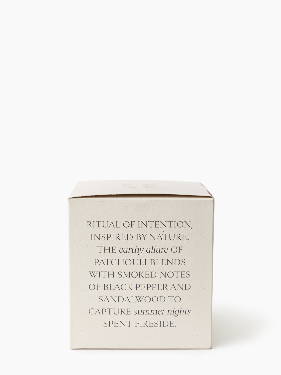 The Palo Santo & Oakmoss Candle comes in a beige box with elegant text: “A luxury soy candle blending earthy patchouli, black pepper, sandalwood, and Palo Santo for a fireside-inspired ritual of intention”, by Vendixs