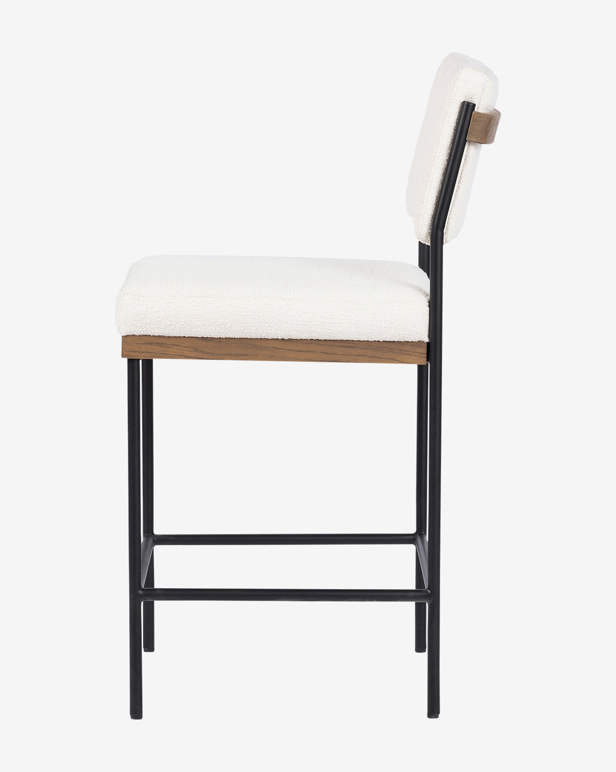 Side view of the Pascal Stool, featuring a white cushioned seat and backrest, slim black iron legs, and a wooden accent below the seat. Its minimalist, contemporary design makes it a versatile addition to modern spaces, by Vendixs