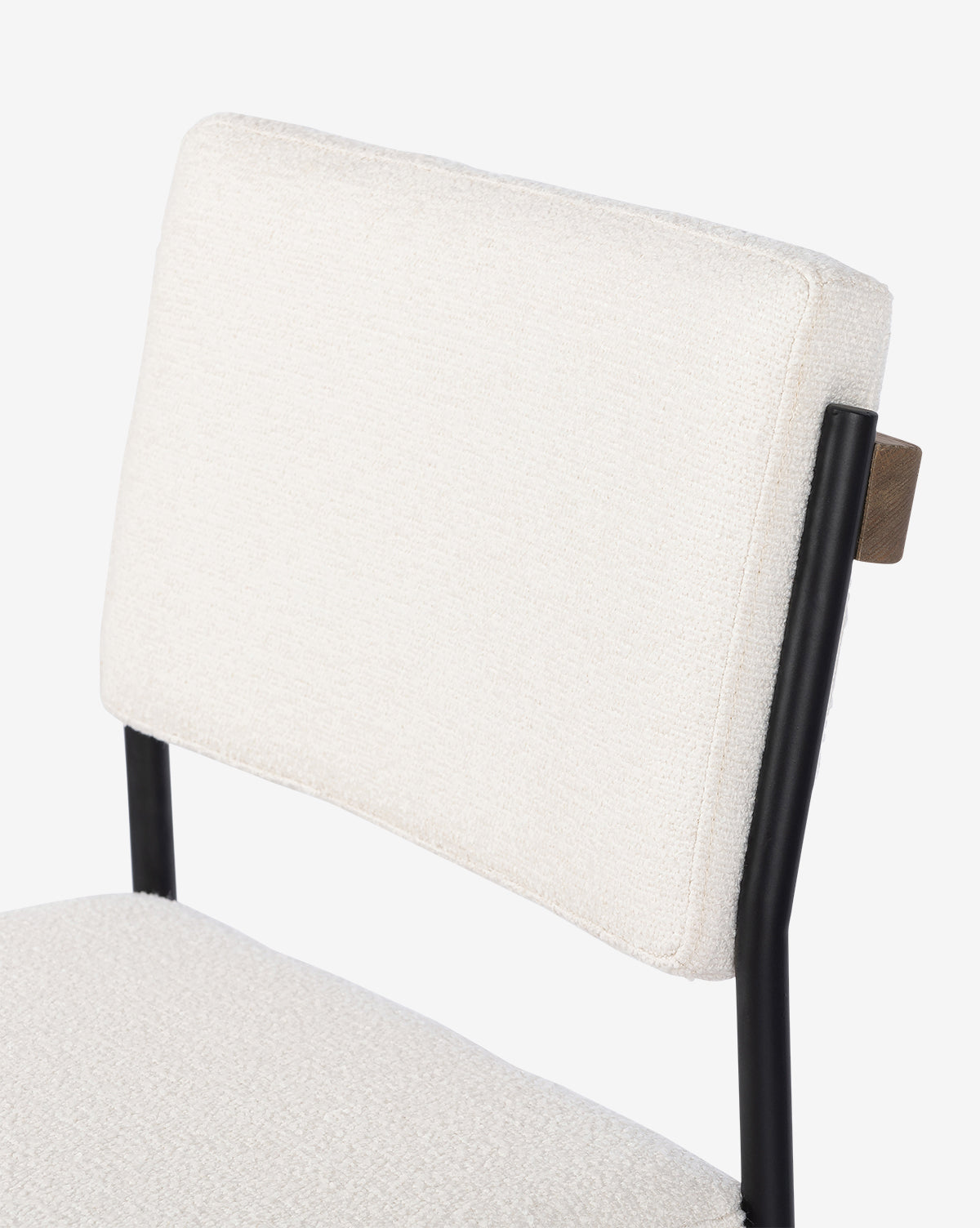 Close-up of the backrest and seat of the Pascal Stool, featuring textured off-white fabric and a black iron frame, set against a plain white background, by Vendixs
