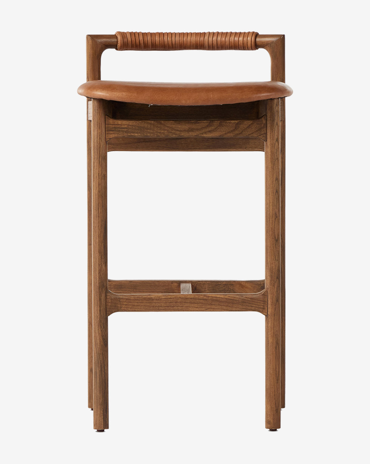 The Four Hands Patrin Stool showcases an ash wood frame and a curved seat, with a horizontal backrest wrapped in leather or wicker, shown front-facing against a white background. Vendixs