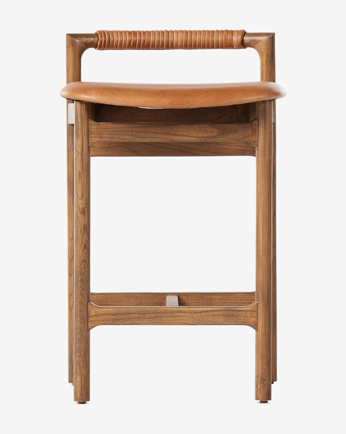 The Patrin Stool by Four Hands boasts an ash wood frame, a curved performance-upholstered seat, and a cylindrical leather-wrapped backrest. Straight legs with crossbars enhance its minimalist, modern style by Vendixs