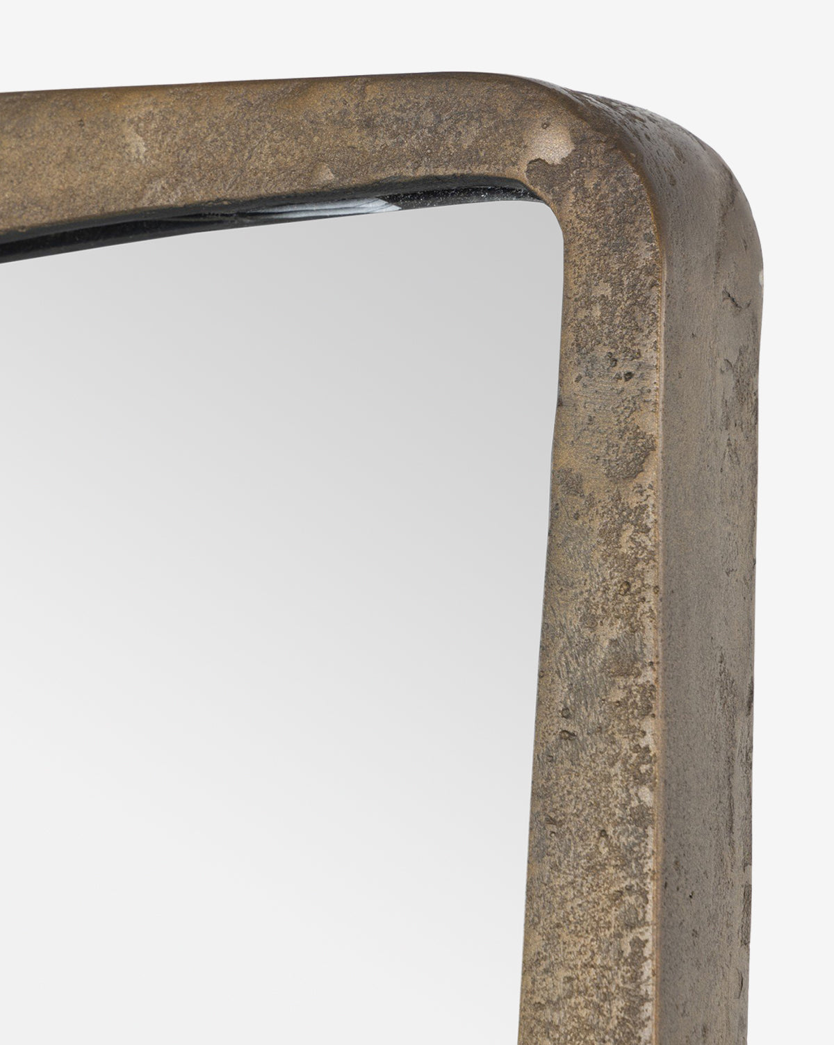Close-up of the top corner of the Penrod Floor Mirror, featuring a thick, rustic cast aluminum frame ideal for sculptural home decor, set against a white background, by Vendixs