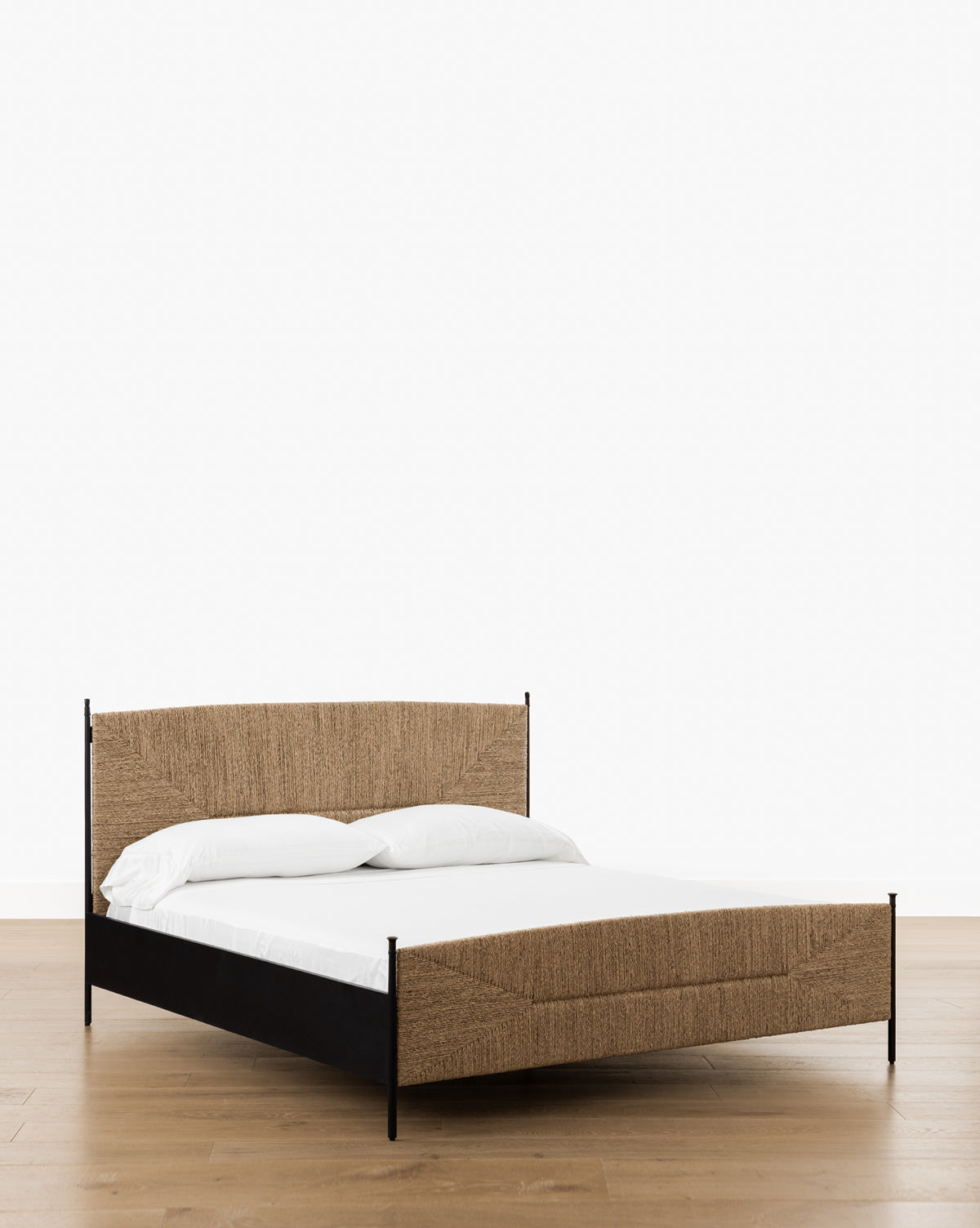 Vendixs metal bed frame with seagrass headboard and footboard.