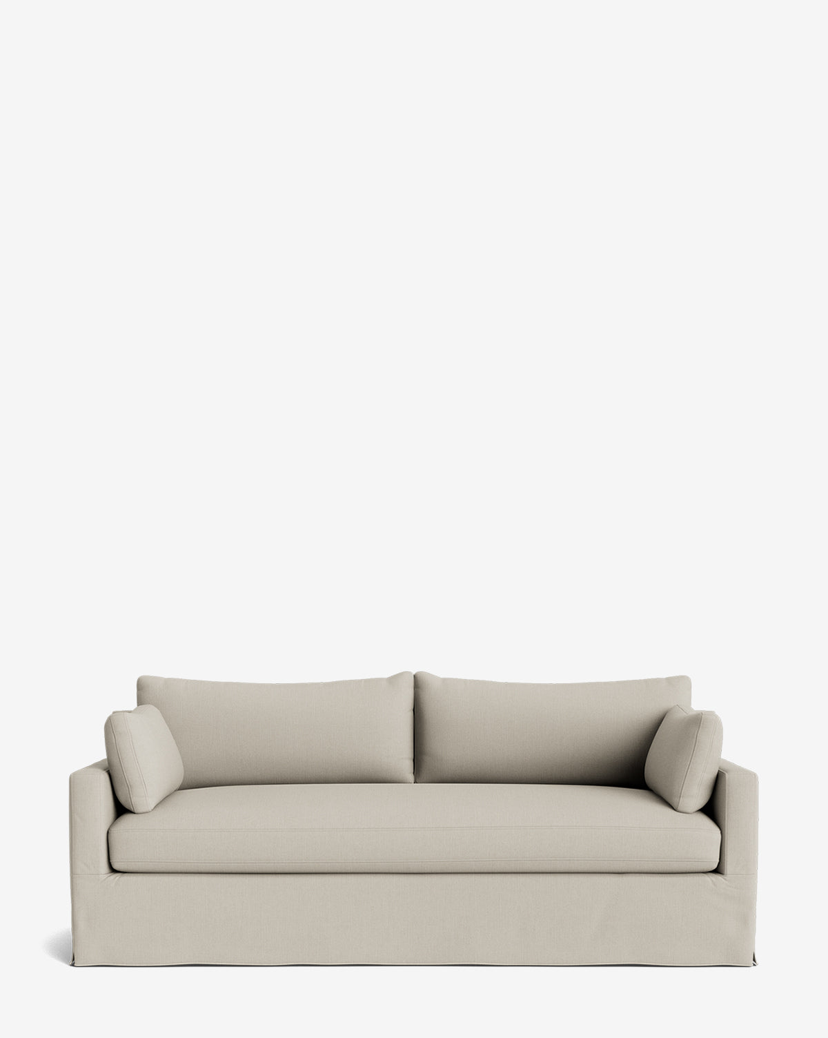 A modern Peterson Classic Slipcover Sofa (75-100) in light beige, featuring a boxy design, feather blend cushions, and two cylindrical side pillows, is displayed against a plain white background by Vendixs