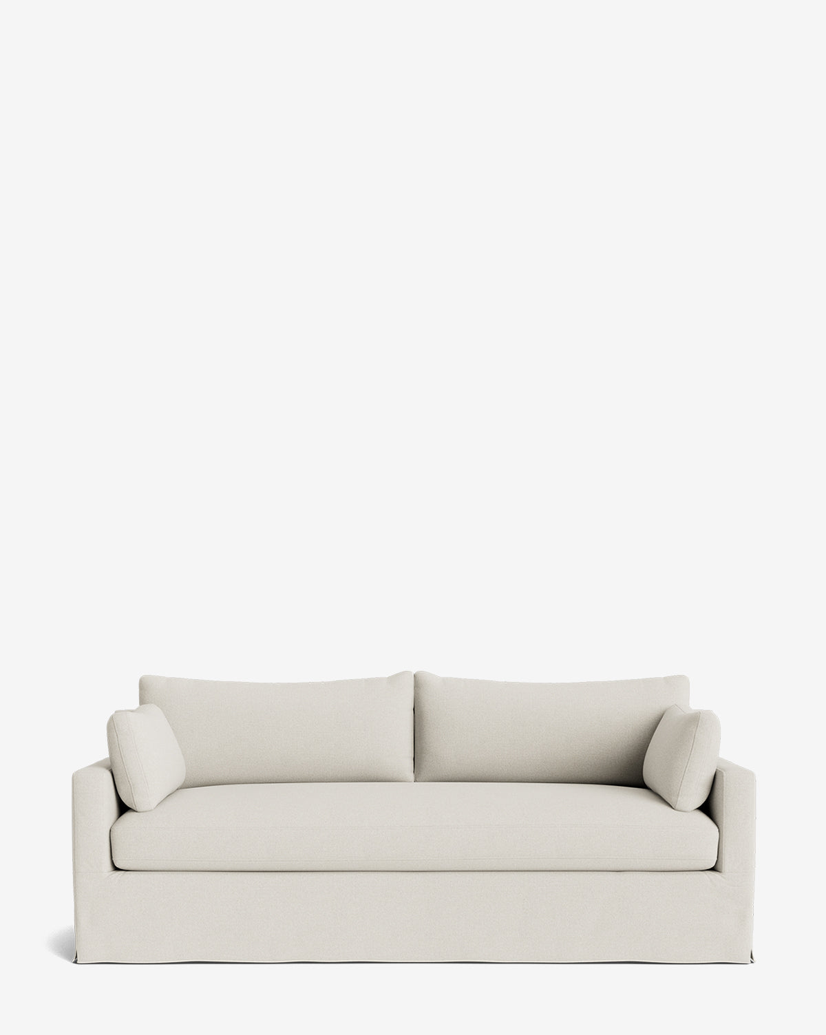 A Peterson Classic Slipcover Sofa (75-100) in light beige with clean lines, two seat cushions, feather blend fill, and matching bolster pillows is shown against a plain white background by Vendixs