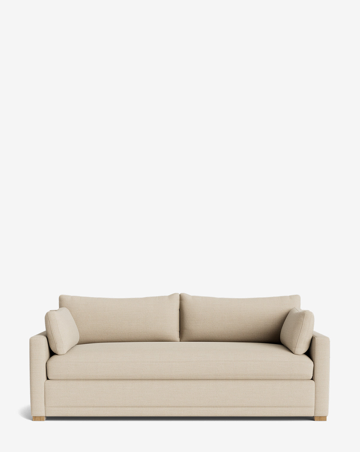 The Peterson Deep Upholstered Sofa (75-100) features a modern beige upholstery, clean lines, low arms, two feather blend back cushions, cylindrical side pillows, and wooden legs—all set against a plain white background by McGee & Co.