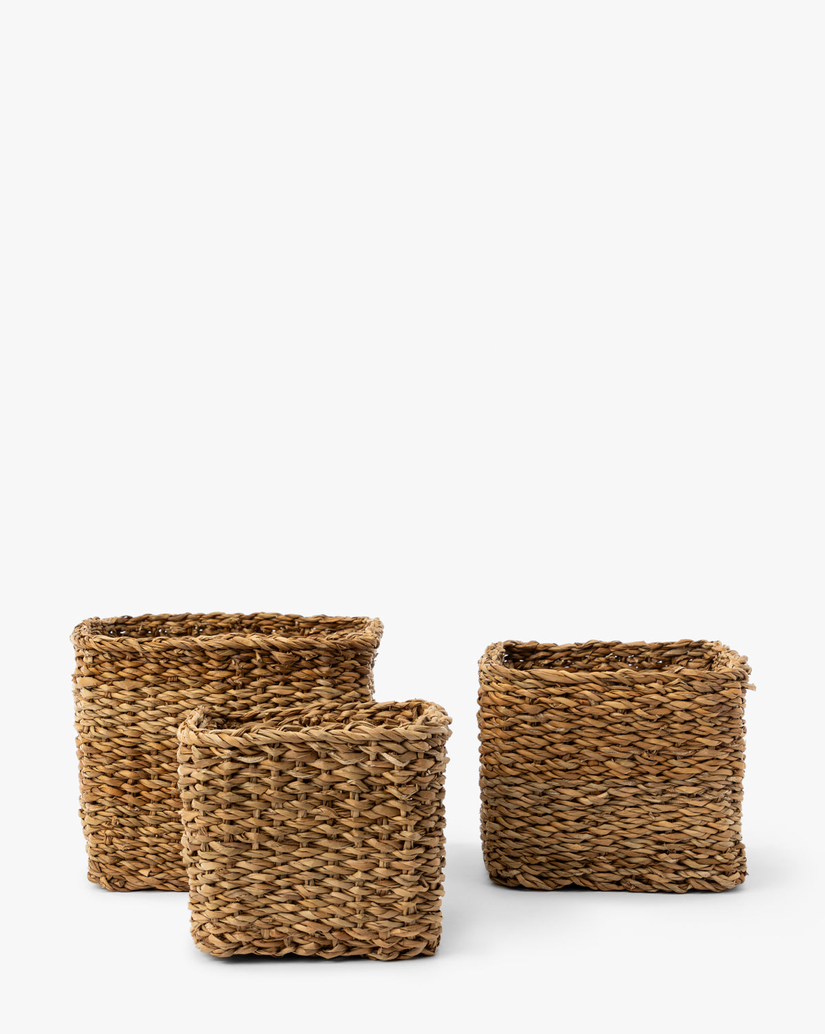 The Piers Baskets (Set of 3) features square woven baskets in varying sizes, crafted from natural fibers with braided patterns and open tops, displayed against a plain white background by Vendixs