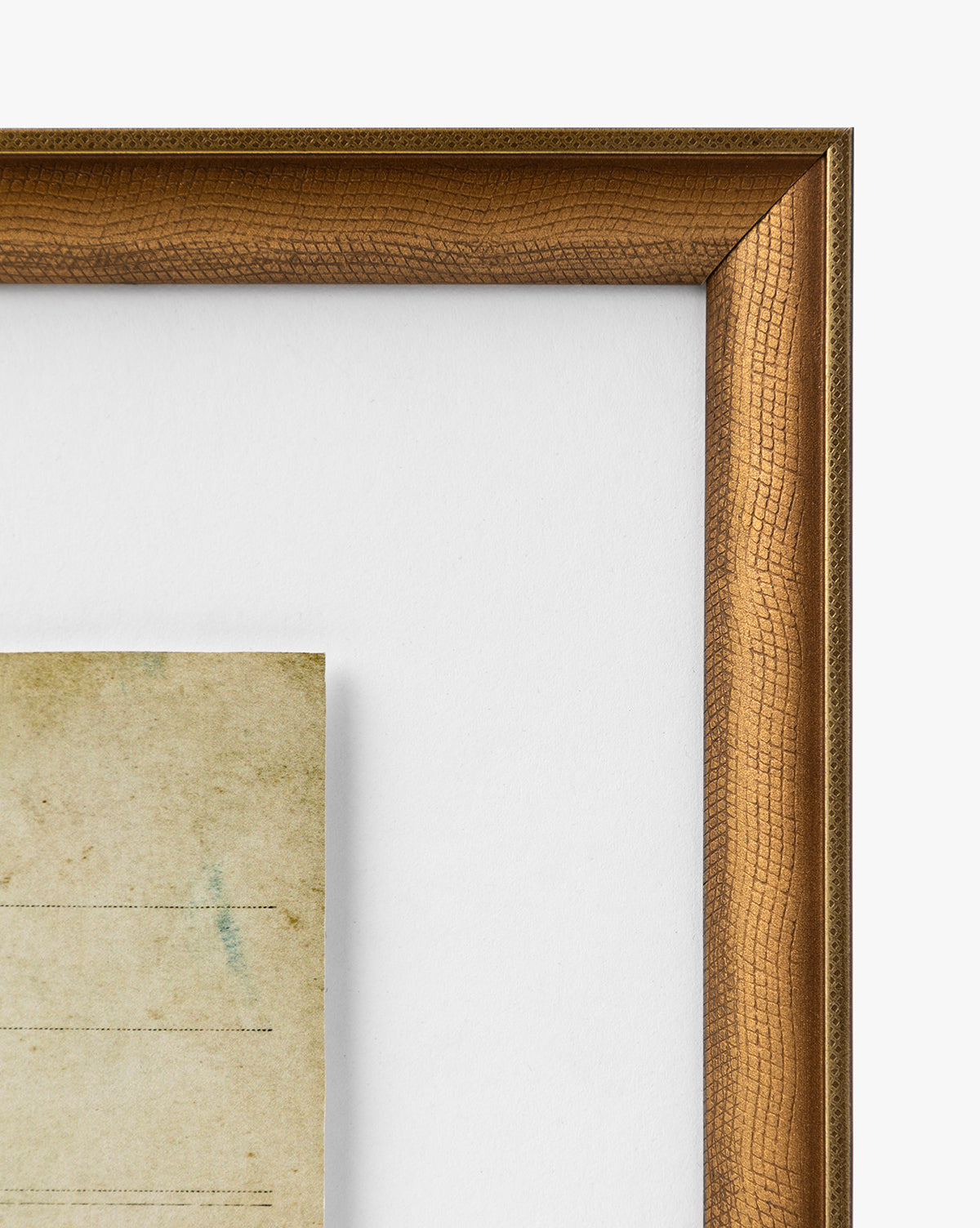 Close-up of the top right corner of a warm brown, gold-finished Post Card Address wood frame with a white mat and part of an aged, yellowed vintage note inside. The visible texture enhances this classic display, by Vendixs