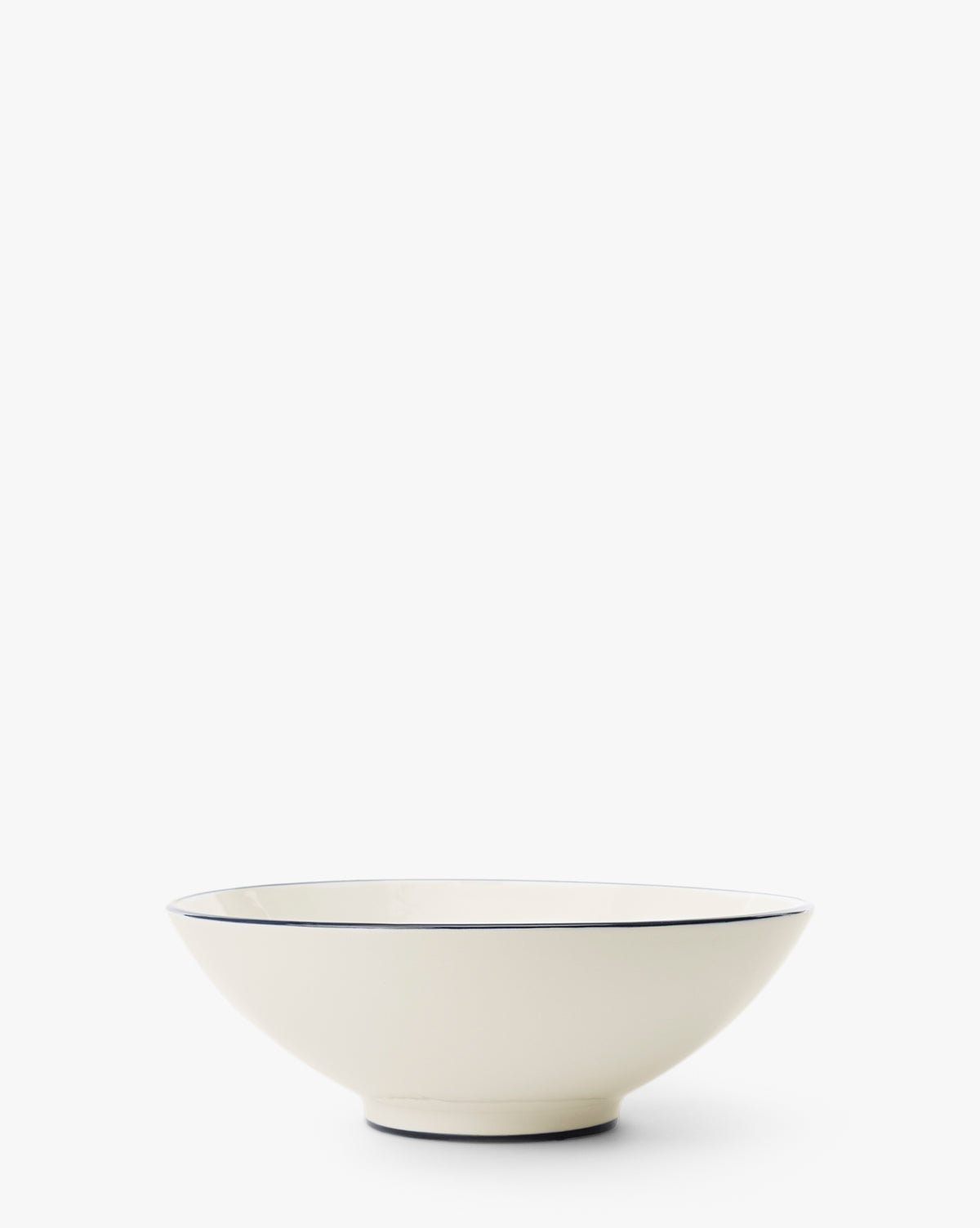 The Pritchard Serving Bowl is a shallow, cream-colored ceramic piece with a slim dark rim, displayed on a plain white background, by Vendixs