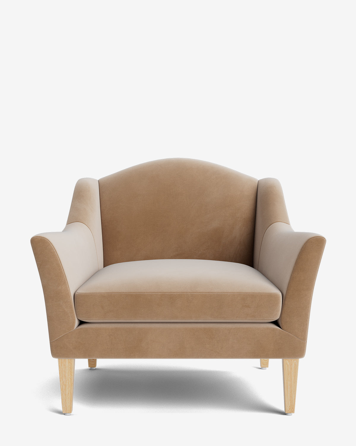 The Prudence Lounge Chair is a spacious, tan velvet armchair with a classic silhouette, curved backrest, angled armrests, and light wooden legs, shown against a plain white background by McGee & Co.