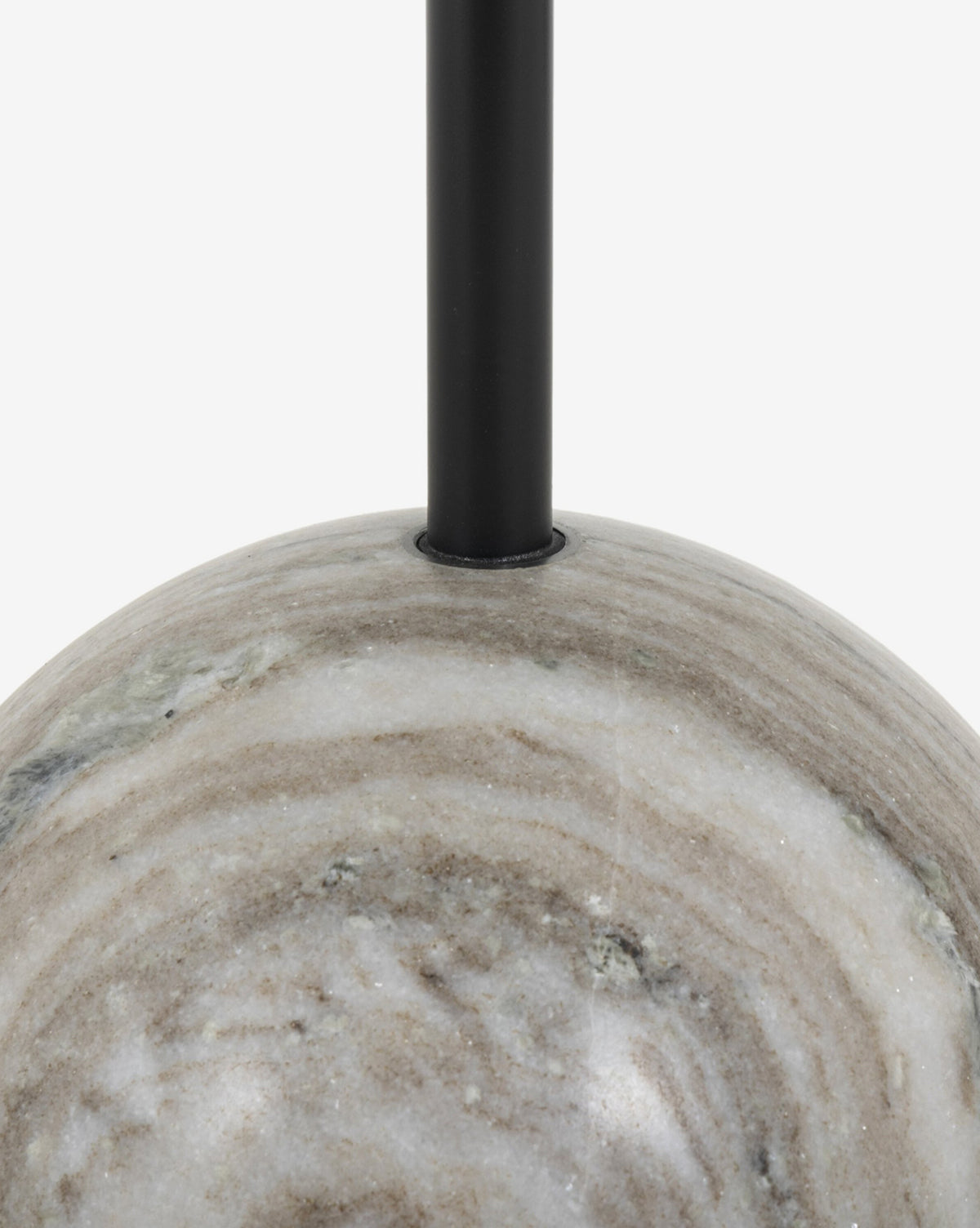 Close-up of the Raelynn End Table’s smooth, round, white marble base with a black metal rod rising from its center—an elegant accent against a plain white background, by McGee & Co.