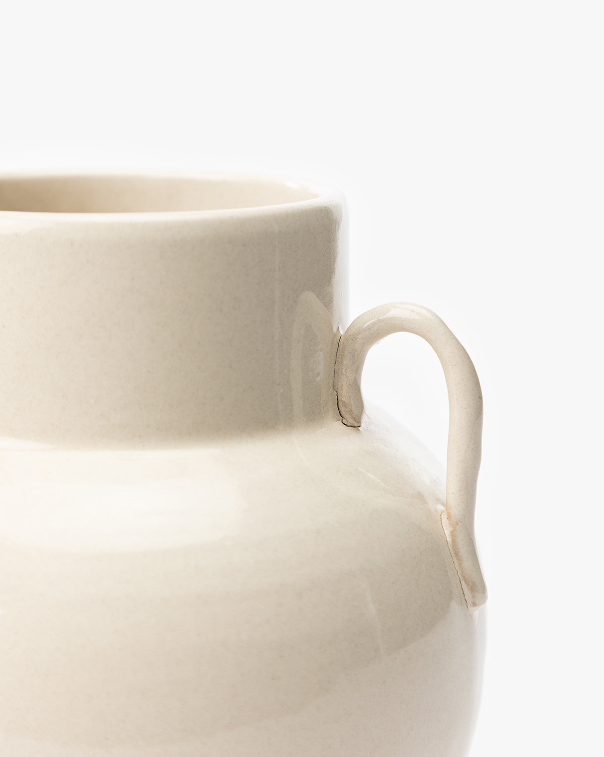 Close-up of the Rasley Handled Jar featuring a cream-colored, curved handle and a smooth, rounded body, set against a plain white background, by Vendixs