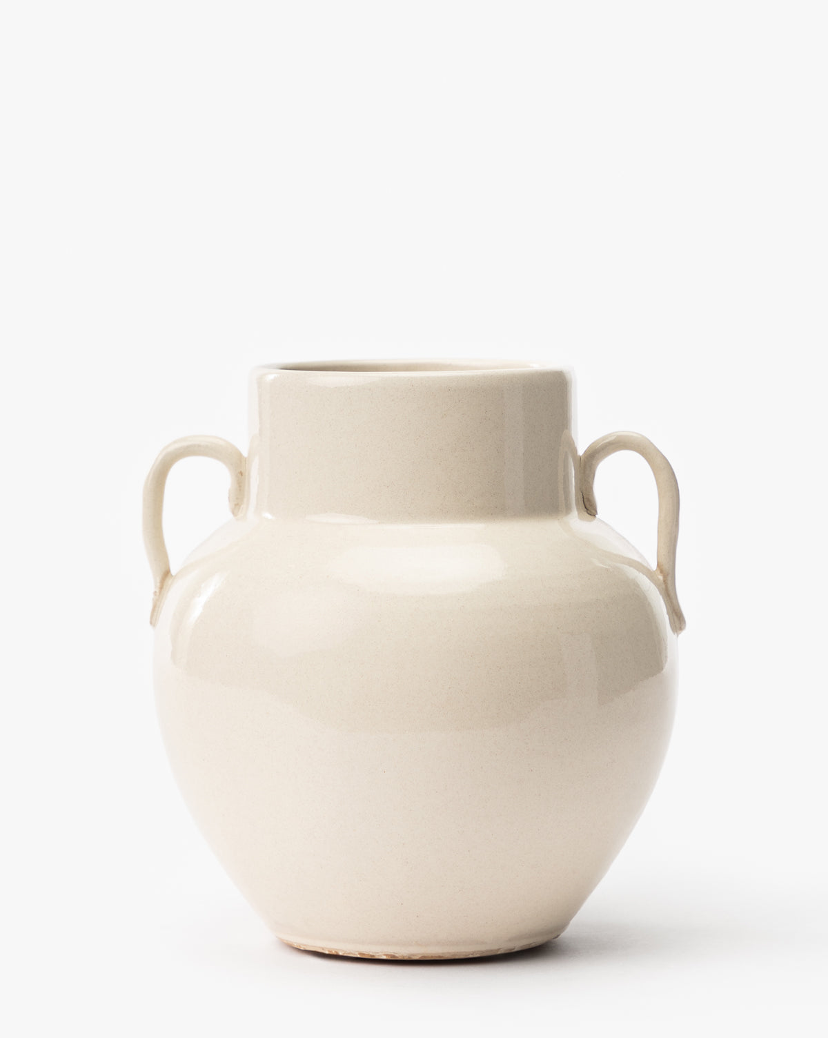 The Rasley Handled Jar, a cream-colored porcelain piece with two small side handles, a rounded body, and a short wide neck, is shown against a plain white background, by Vendixs